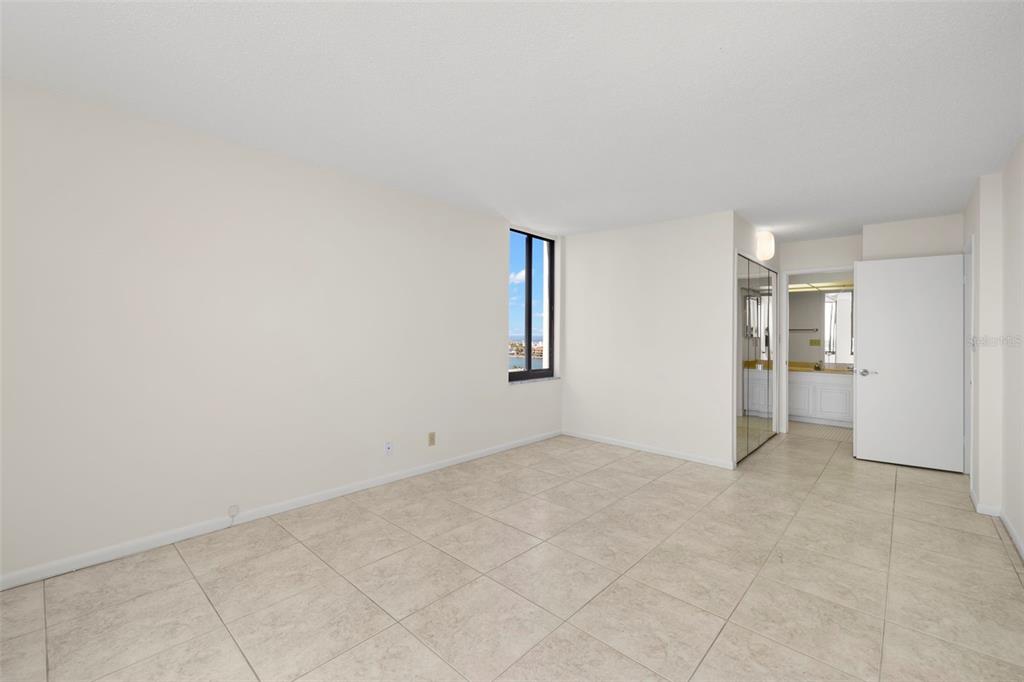 9425 Blind Pass Road, Unit 1008 St. Pete Beach, FL 33706 - Photo 5 of 65 an empty room with closet and windows