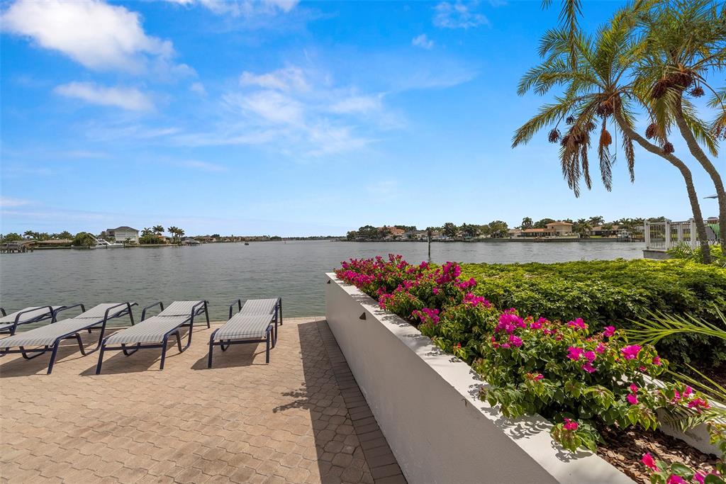 9425 Blind Pass Road, Unit 1008 St. Pete Beach, FL 33706 - Photo 52 of 65 a view of a lake with a patio