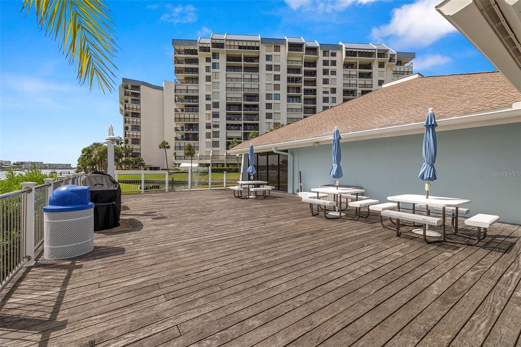 9425 Blind Pass Road, Unit 1008 St. Pete Beach, FL 33706 - Photo 58 of 65 a roof deck view with a table and chairs