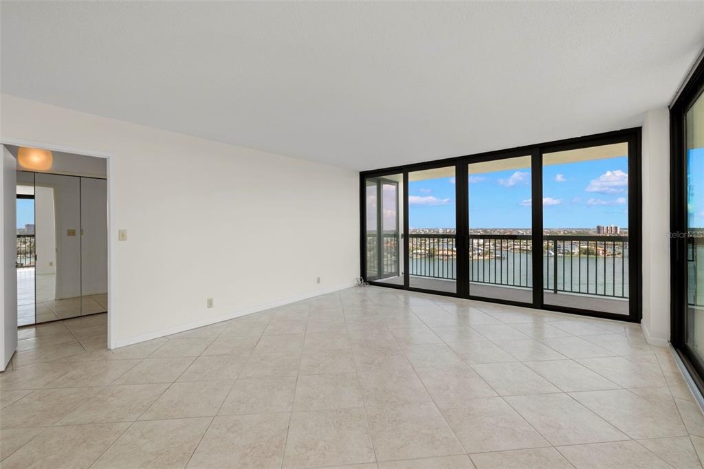 9425 Blind Pass Road, Unit 1008 St. Pete Beach, FL 33706 - Photo 7 of 65 an empty room with windows and city view