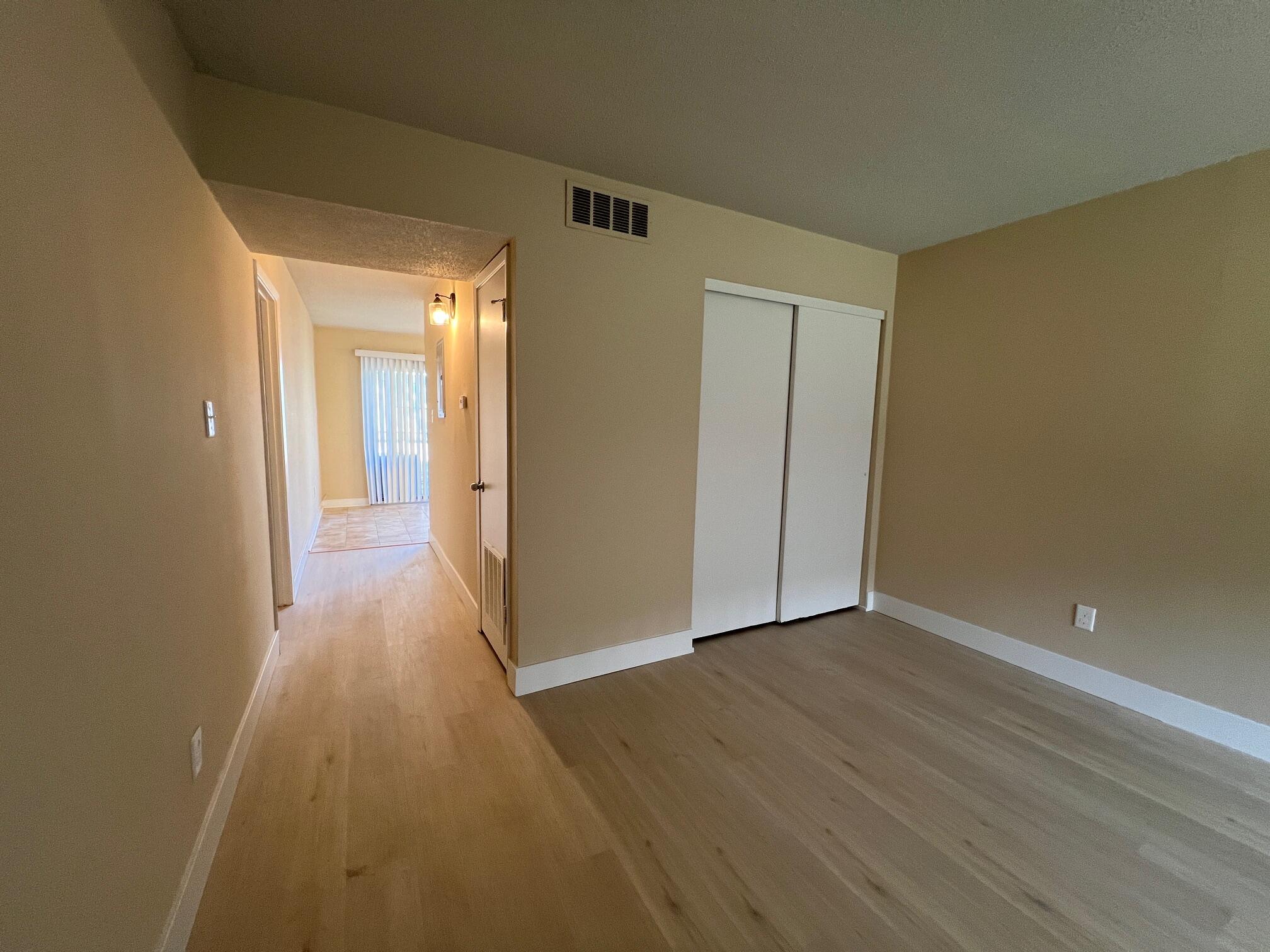 210 Pelham Road, Unit 105B Fort Walton Beach, FL 32547 - Photo 11 of 41 a view of a hallway with wooden floor