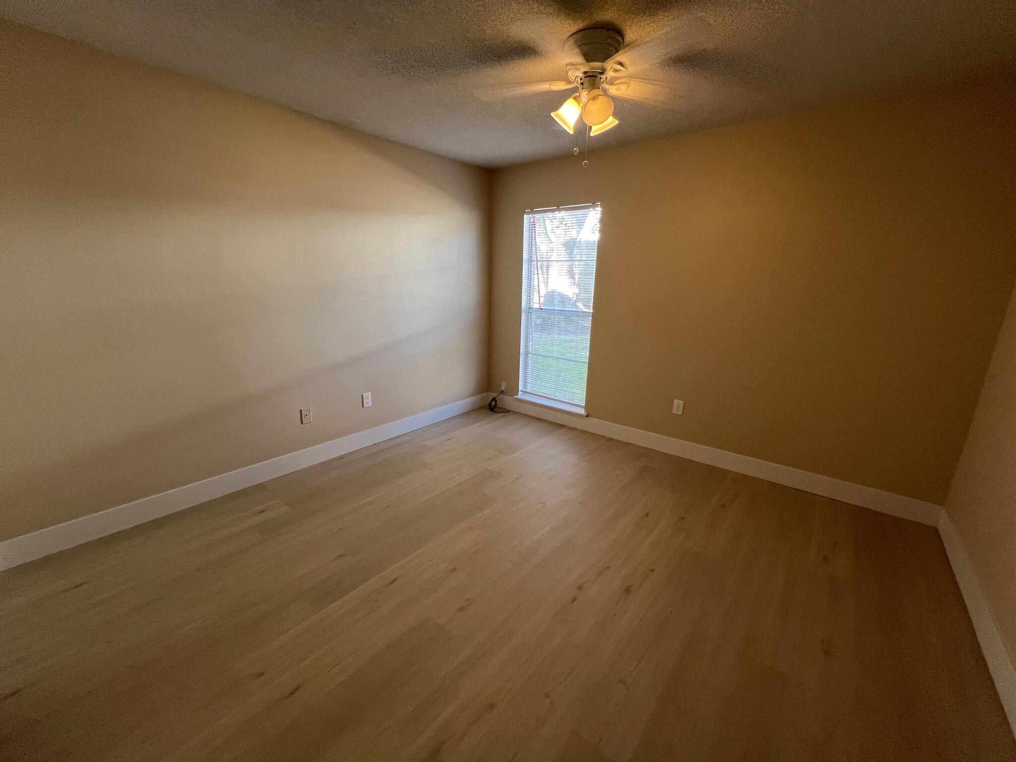210 Pelham Road, Unit 105B Fort Walton Beach, FL 32547 - Photo 18 of 41 an empty room with windows and fan