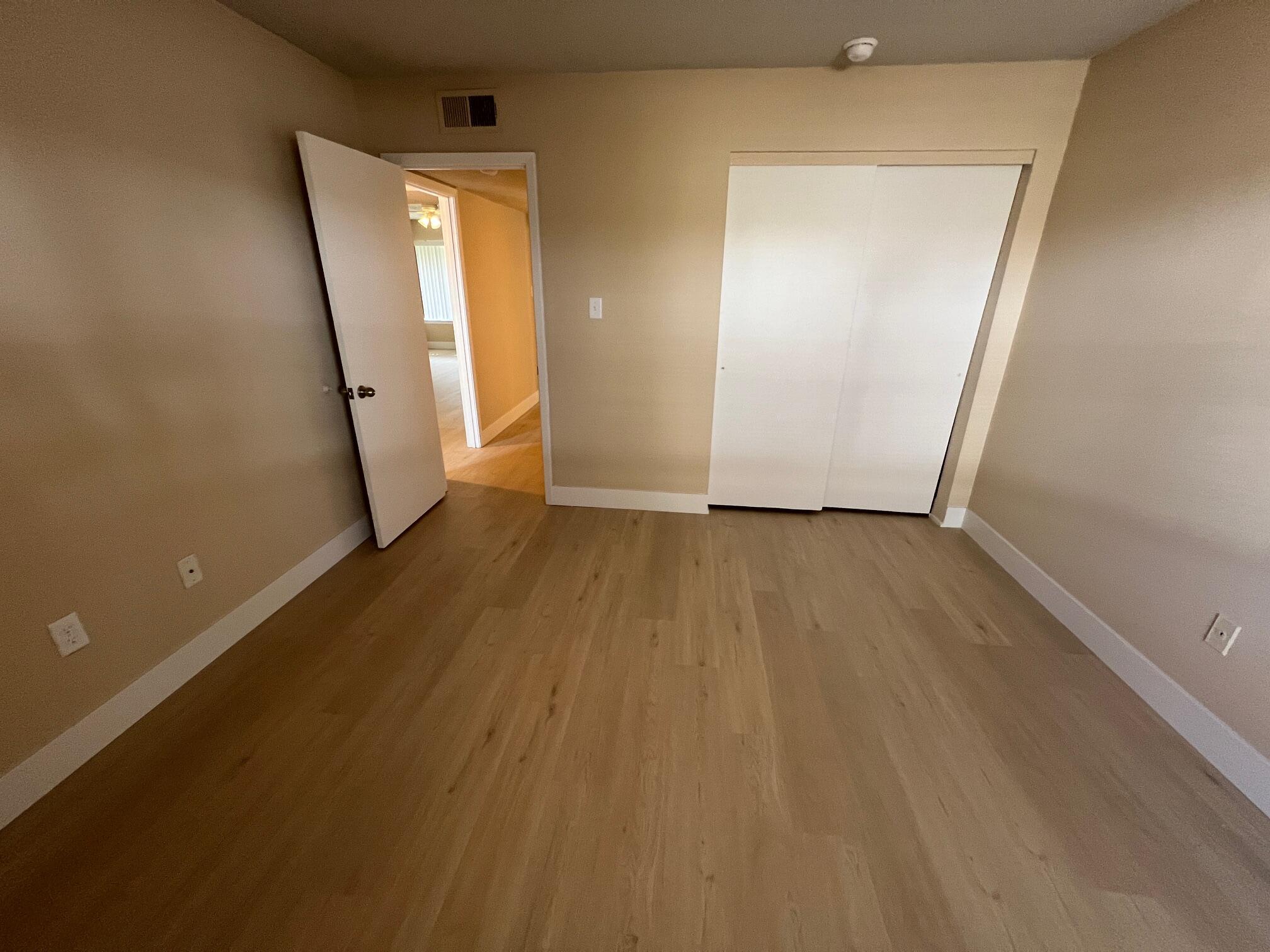 210 Pelham Road, Unit 105B Fort Walton Beach, FL 32547 - Photo 19 of 41 an empty room with wooden floor and a window