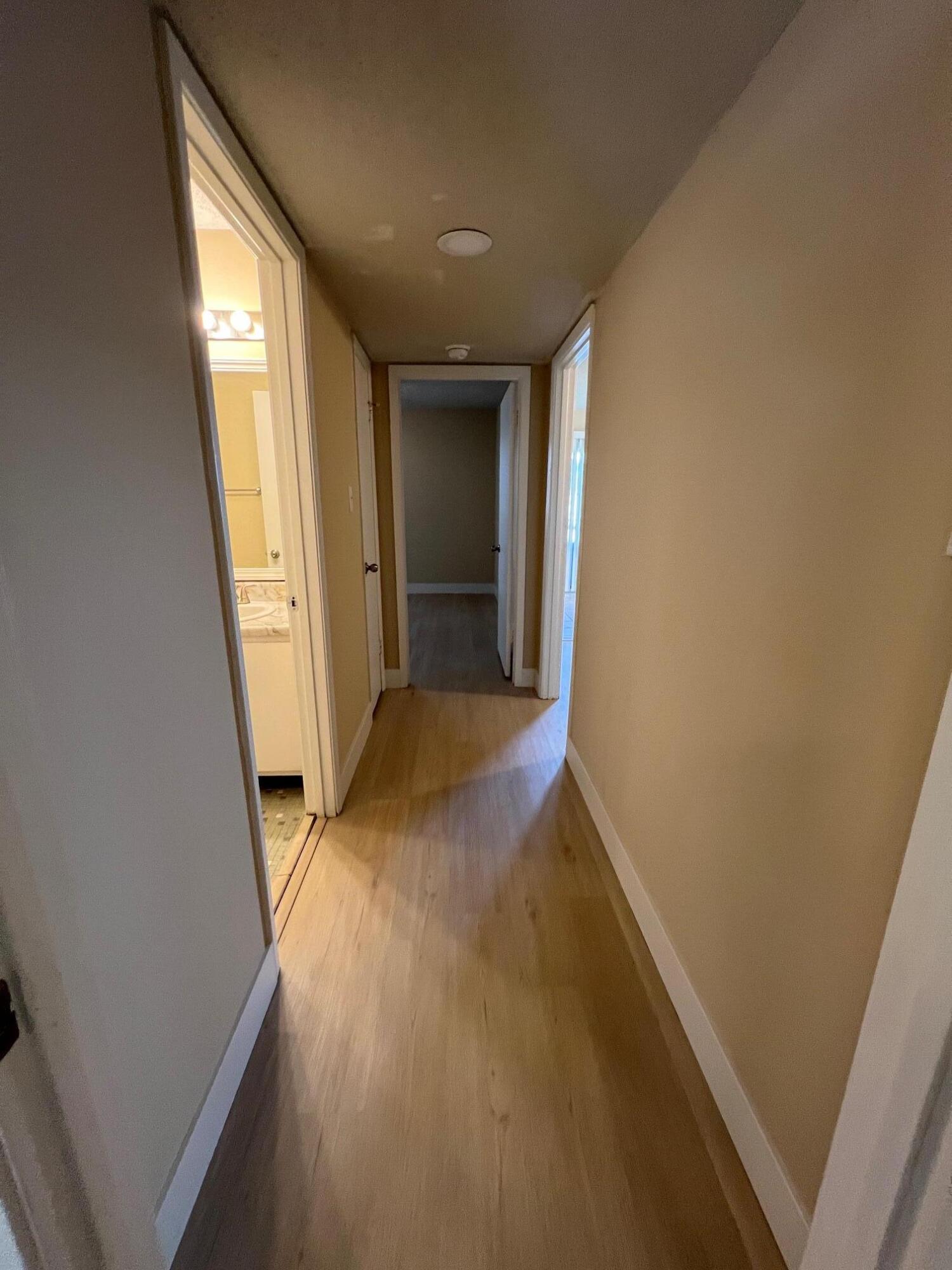 210 Pelham Road, Unit 105B Fort Walton Beach, FL 32547 - Photo 26 of 41 a view of hallway with window and wooden floor