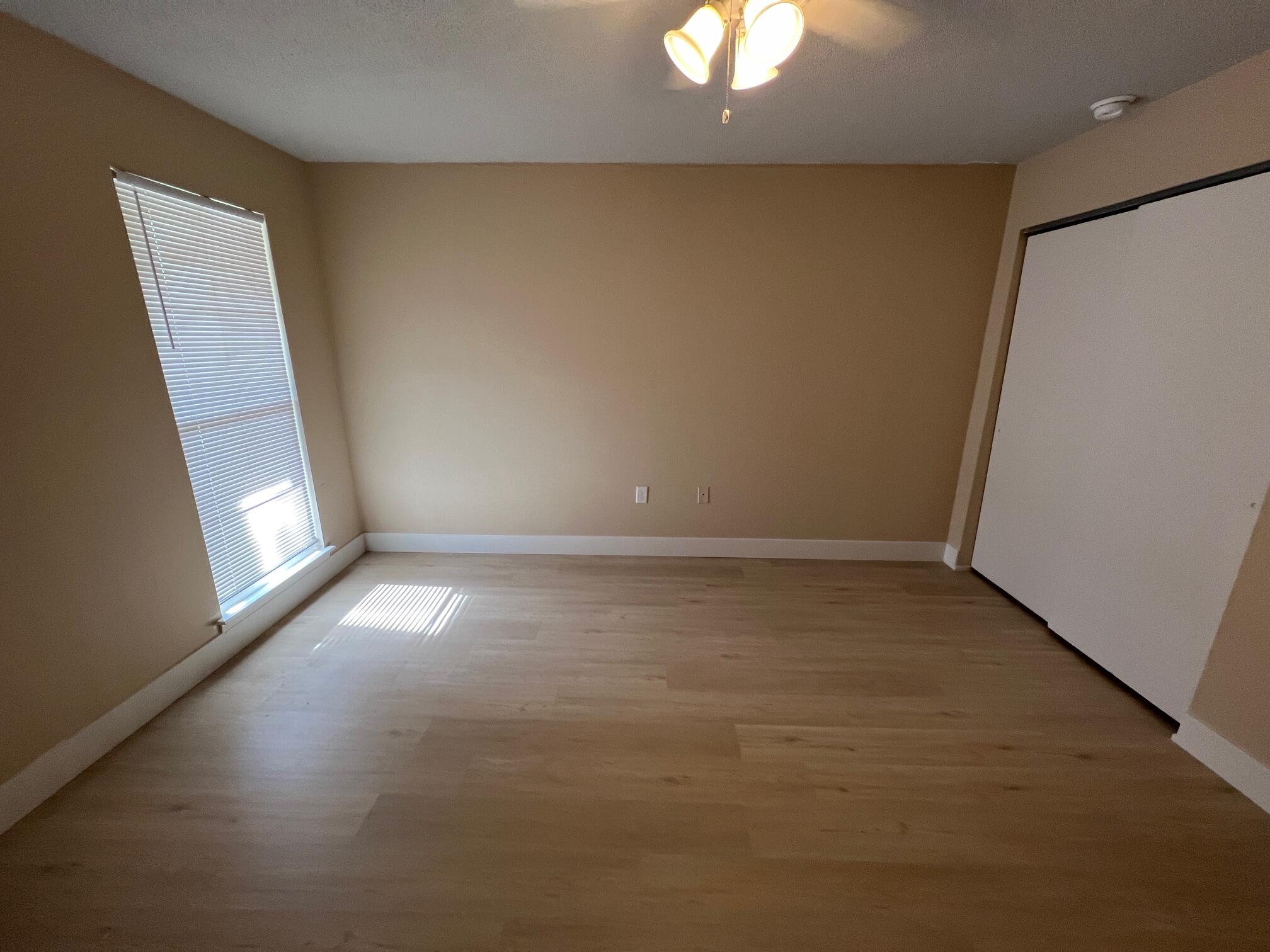 210 Pelham Road, Unit 105B Fort Walton Beach, FL 32547 - Photo 29 of 41 en empty room with windows and chandelier fan