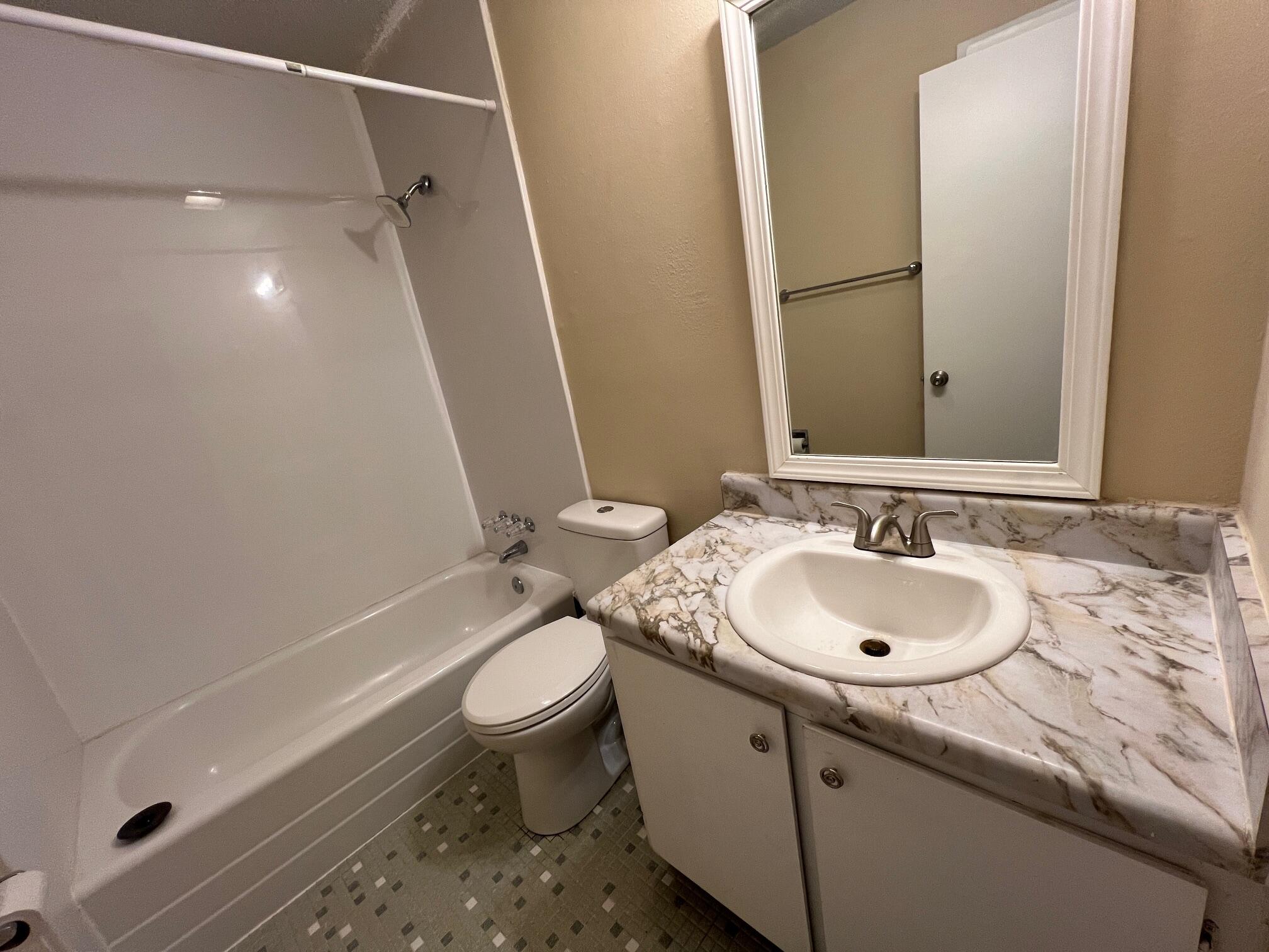 210 Pelham Road, Unit 105B Fort Walton Beach, FL 32547 - Photo 32 of 41 a bathroom with a sink and a mirror