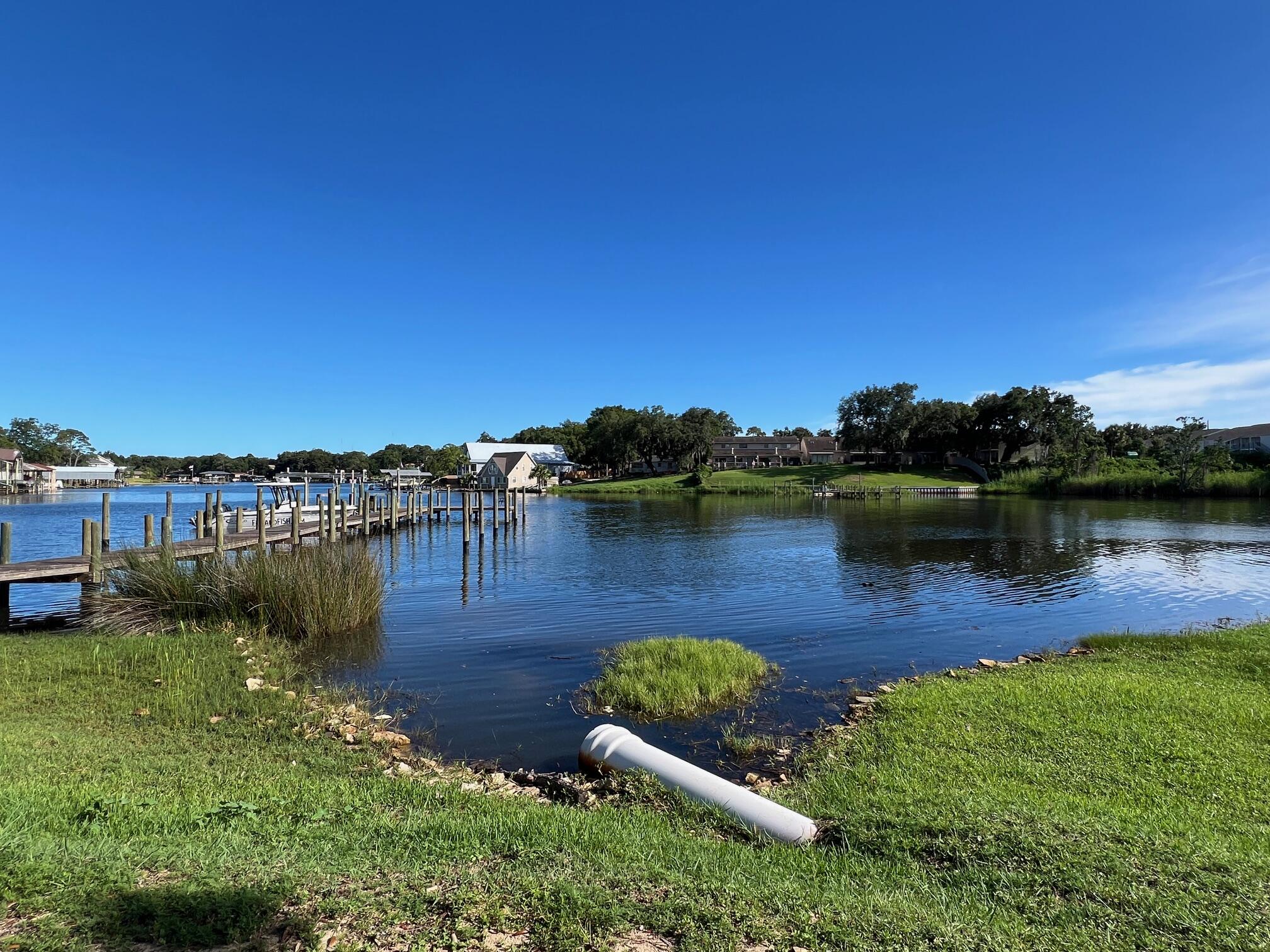 210 Pelham Road, Unit 105B Fort Walton Beach, FL 32547 - Photo 36 of 41 a view of a lake with houses in the back