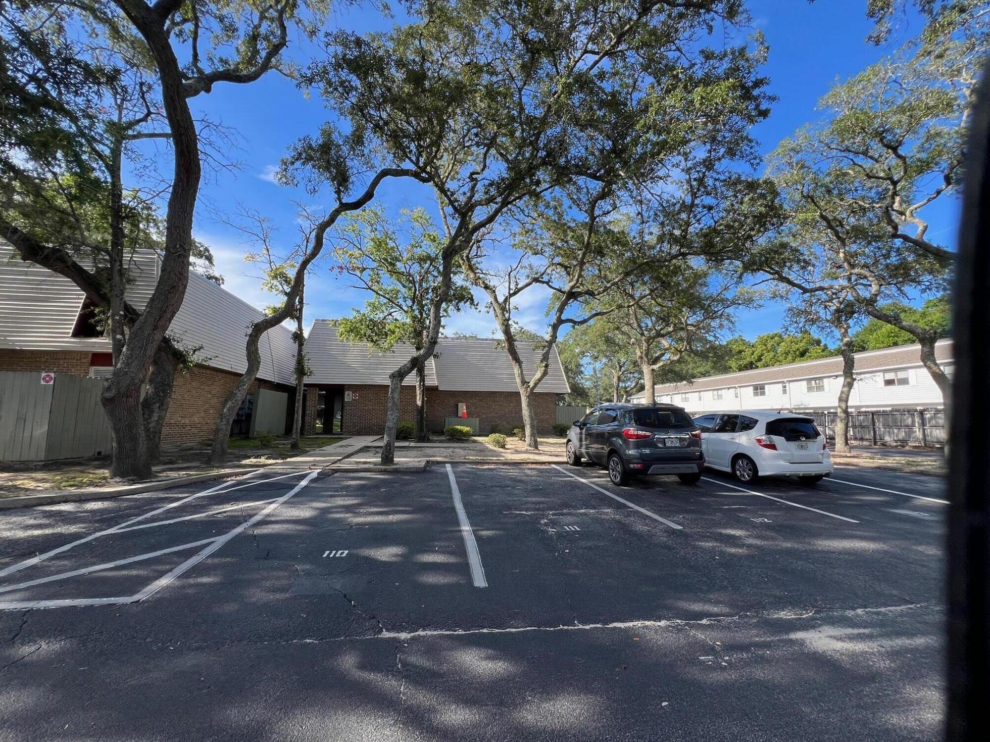 210 Pelham Road, Unit 105B Fort Walton Beach, FL 32547 - Photo 41 of 41 a view of a cars parked on the side of a street
