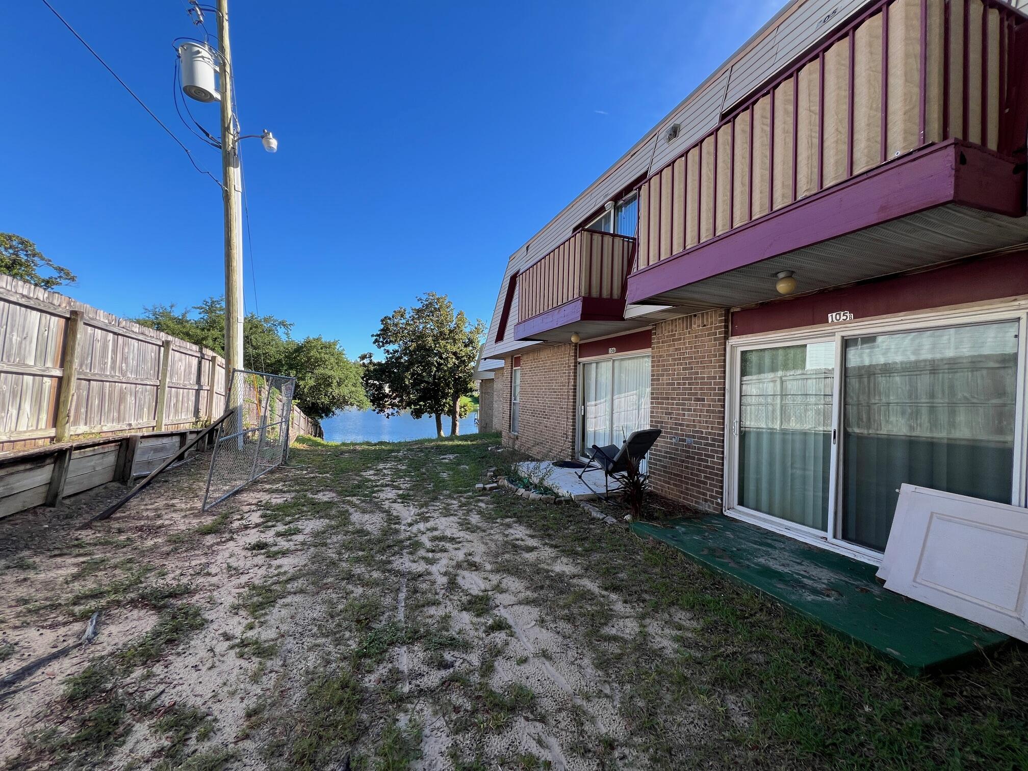 210 Pelham Road, Unit 105B Fort Walton Beach, FL 32547 - Photo 6 of 41 a view of a house with a yard