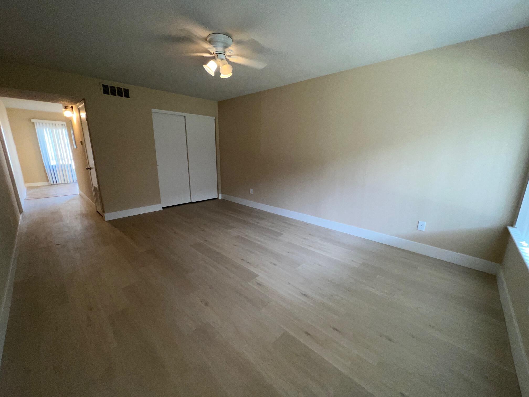 210 Pelham Road, Unit 105B Fort Walton Beach, FL 32547 - Photo 7 of 41 wooden floor in an empty room with a window