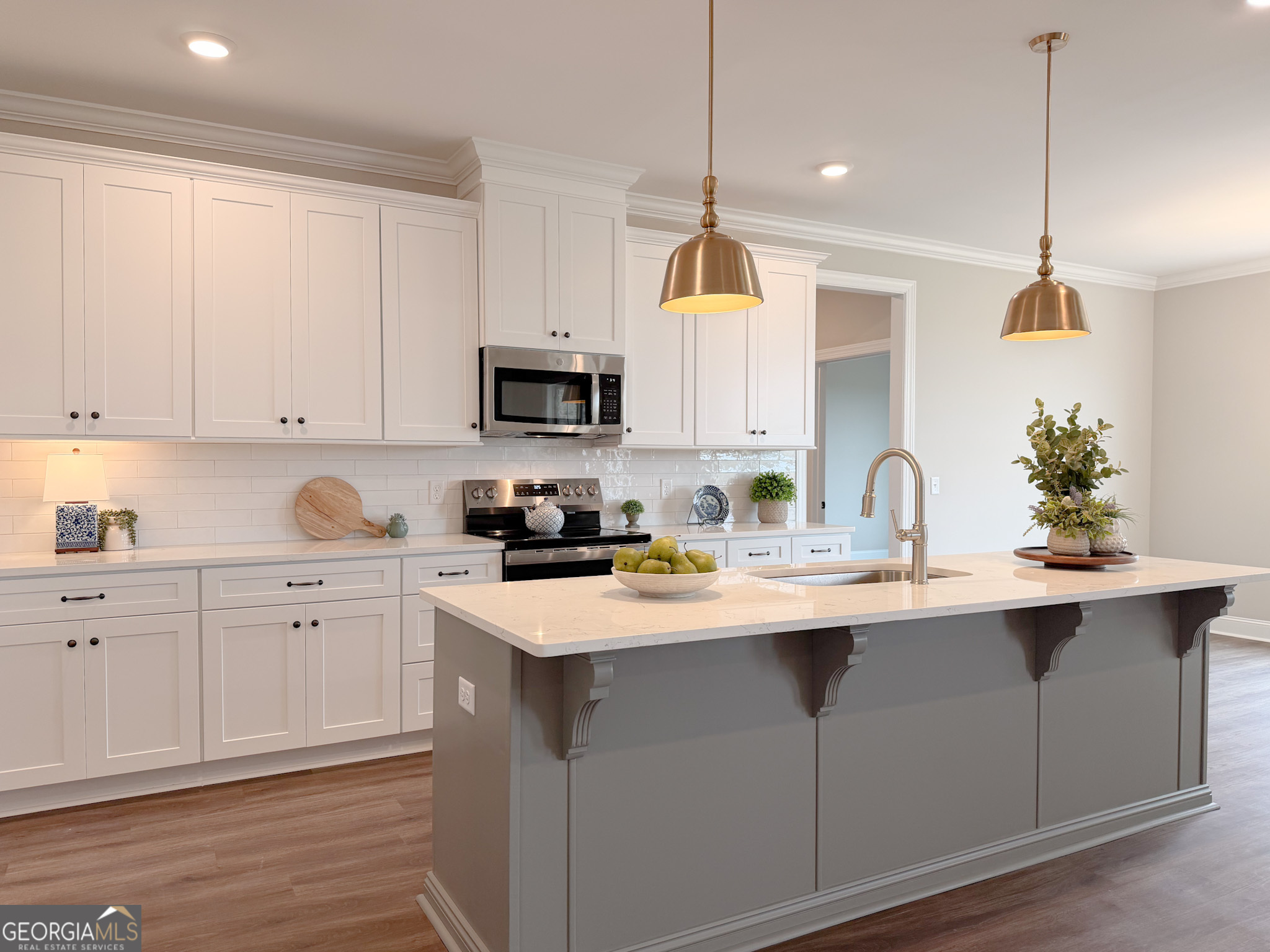 9 Honeysuckle Way Claxton, GA 30417 - Photo 11 of 84 a kitchen with kitchen island granite countertop a sink a stove and cabinets