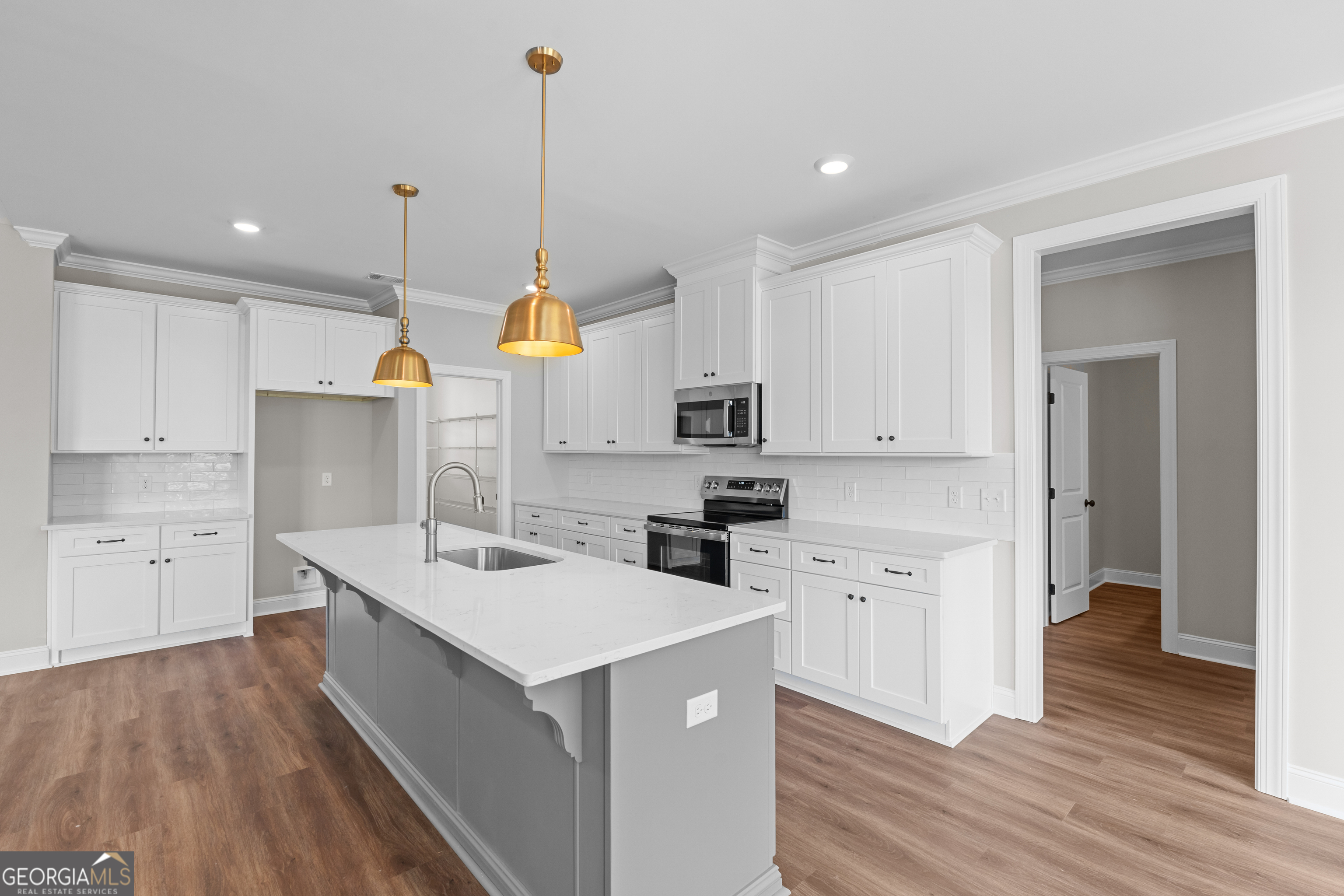 9 Honeysuckle Way Claxton, GA 30417 - Photo 12 of 46 a kitchen with white cabinets and sink