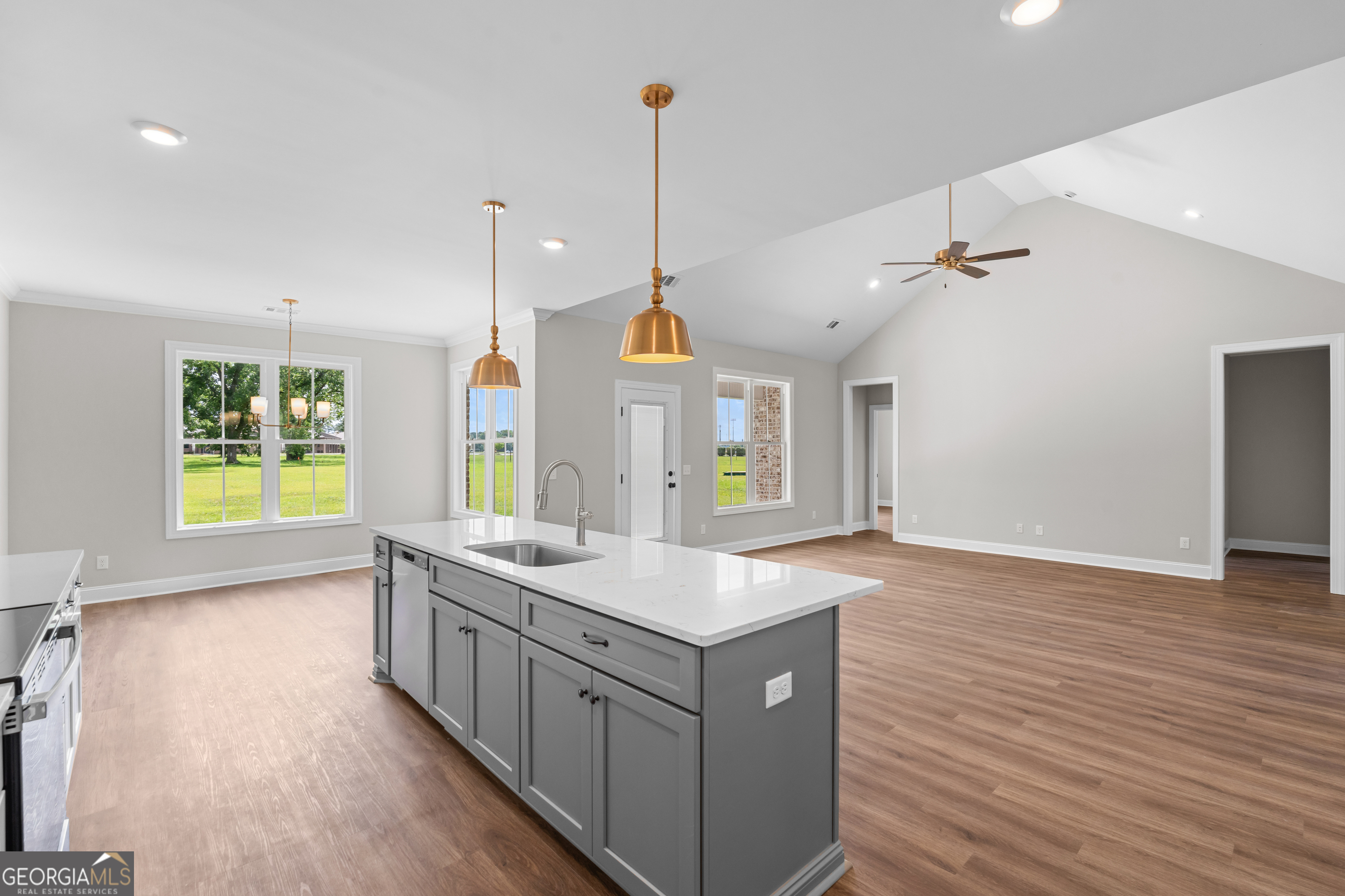 9 Honeysuckle Way Claxton, GA 30417 - Photo 15 of 46 a large kitchen with kitchen island a stove a sink a center island and wooden floor