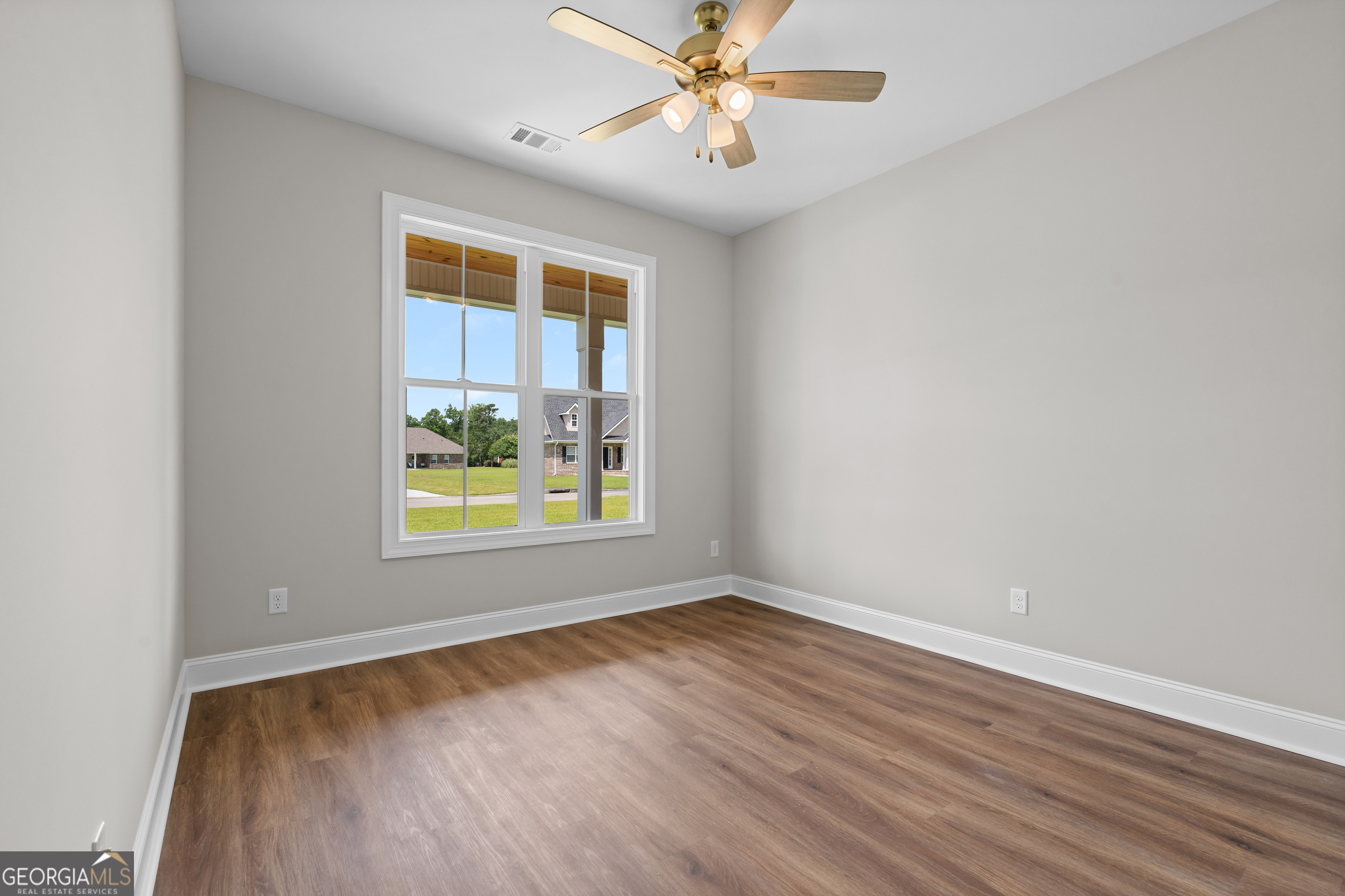 9 Honeysuckle Way Claxton, GA 30417 - Photo 23 of 46 an empty room with a window and wooden floor