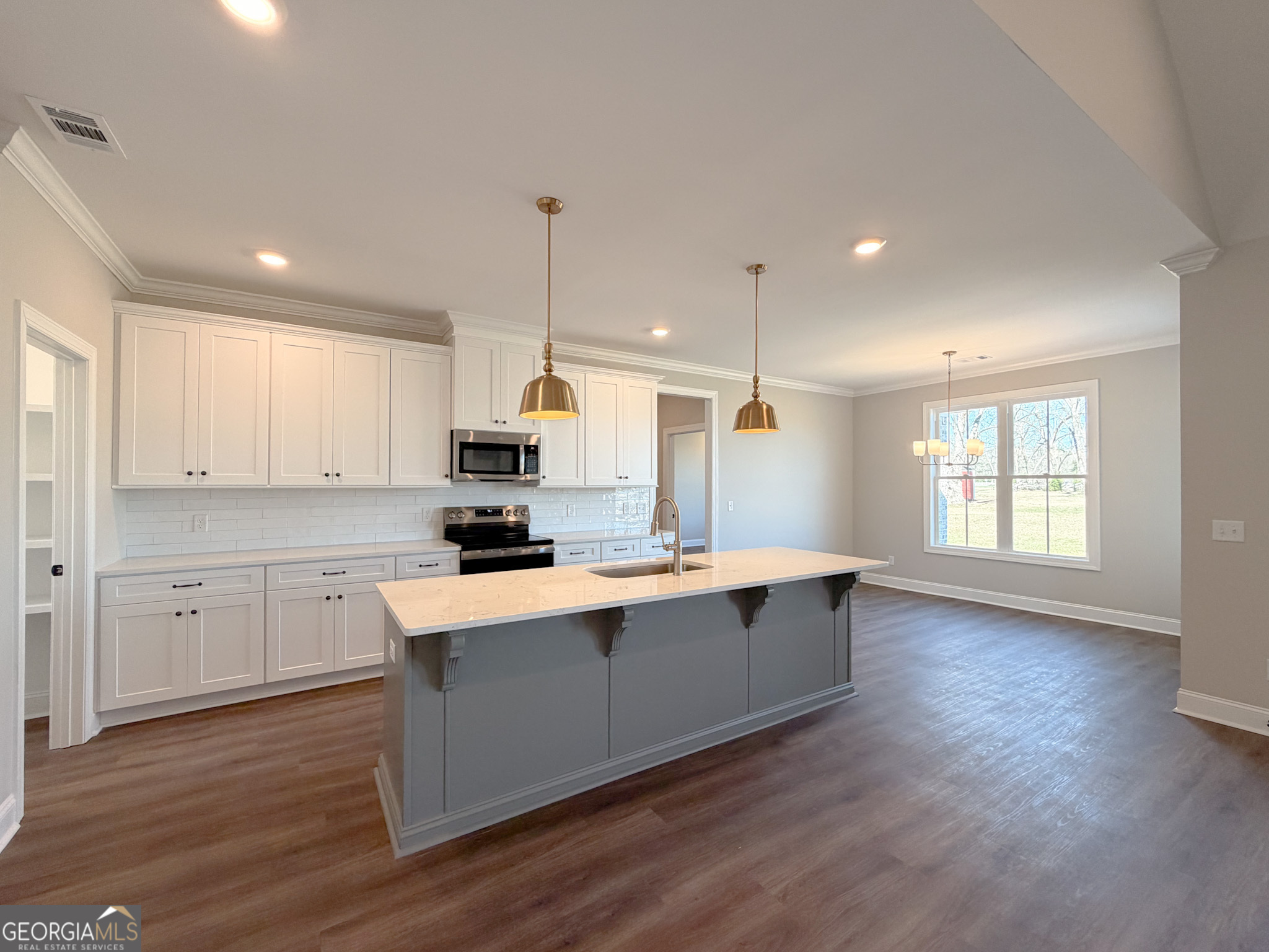 9 Honeysuckle Way Claxton, GA 30417 - Photo 24 of 84 a large kitchen with granite countertop a sink a counter space appliances and cabinets
