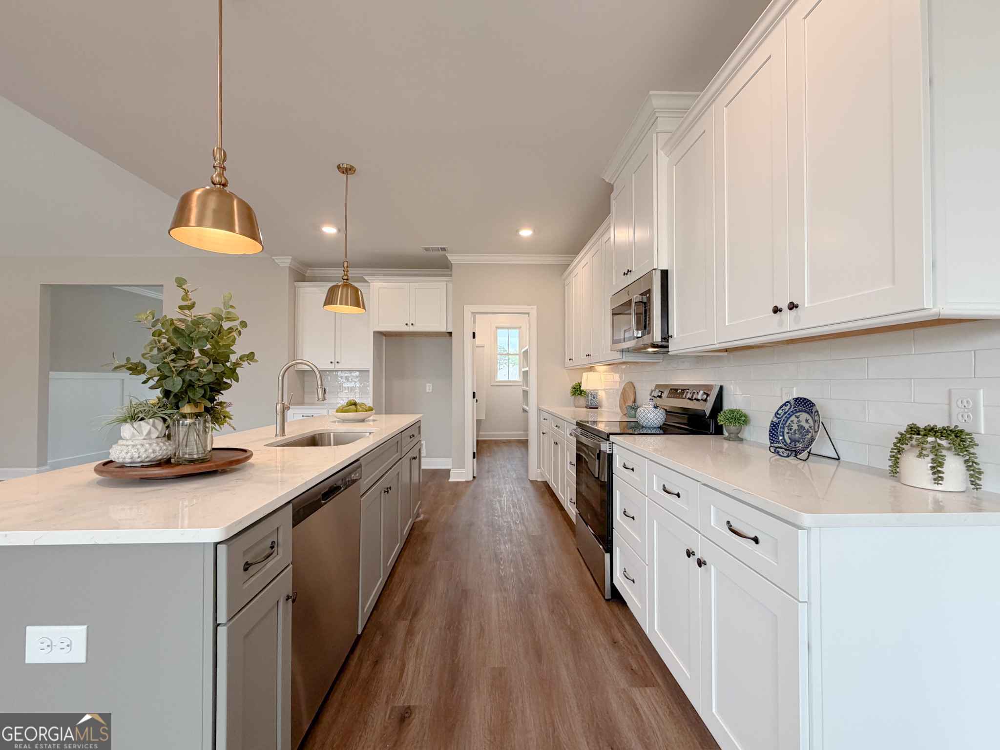 9 Honeysuckle Way Claxton, GA 30417 - Photo 28 of 84 a kitchen with kitchen island granite countertop a sink a counter space appliances and cabinets