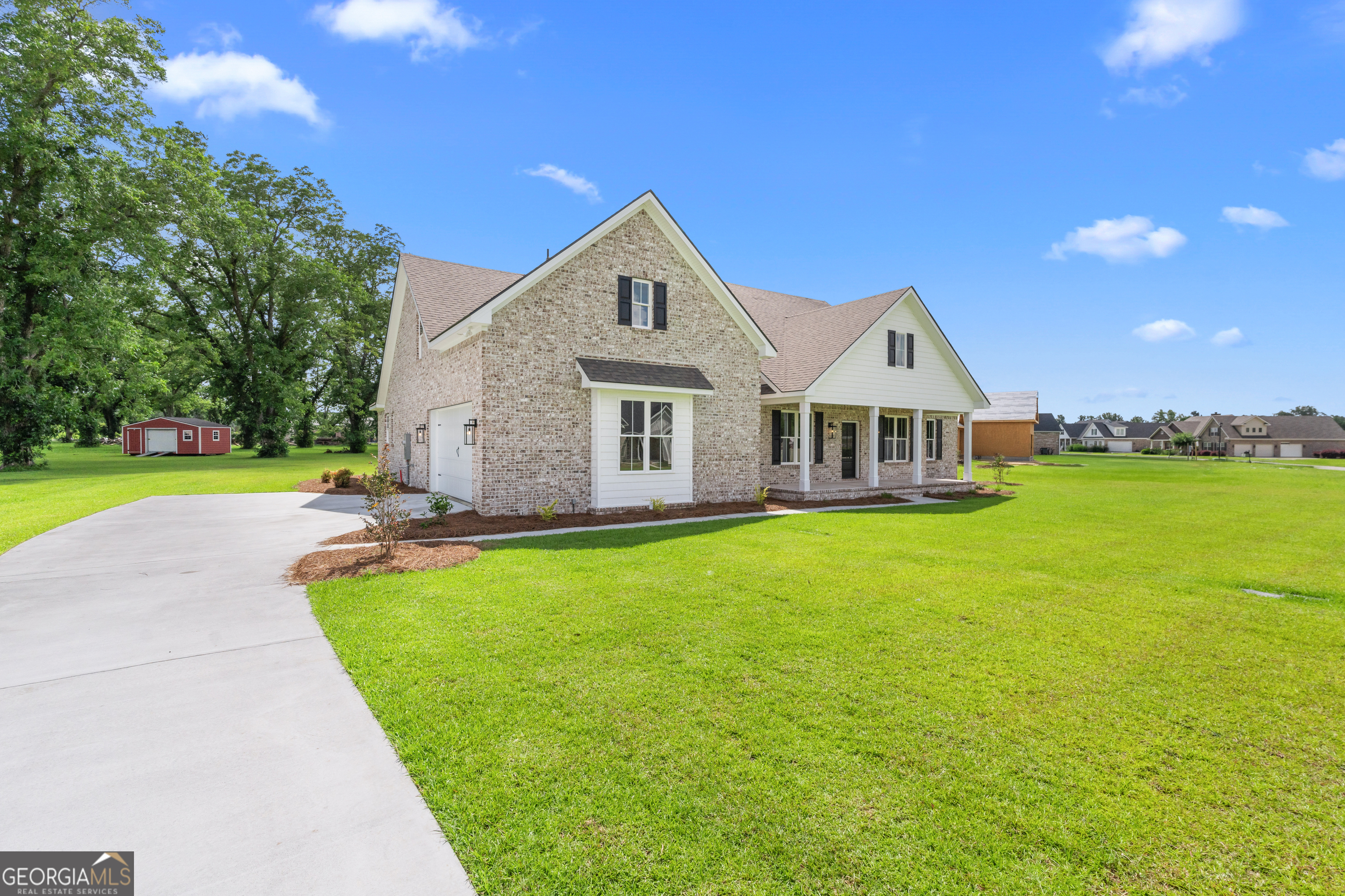 9 Honeysuckle Way Claxton, GA 30417 - Photo 3 of 84 a front view of a house with garden