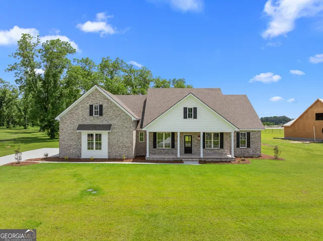 a view of backyard with swimming pool and outdoor seating