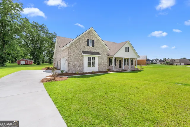 a front view of a house with garden