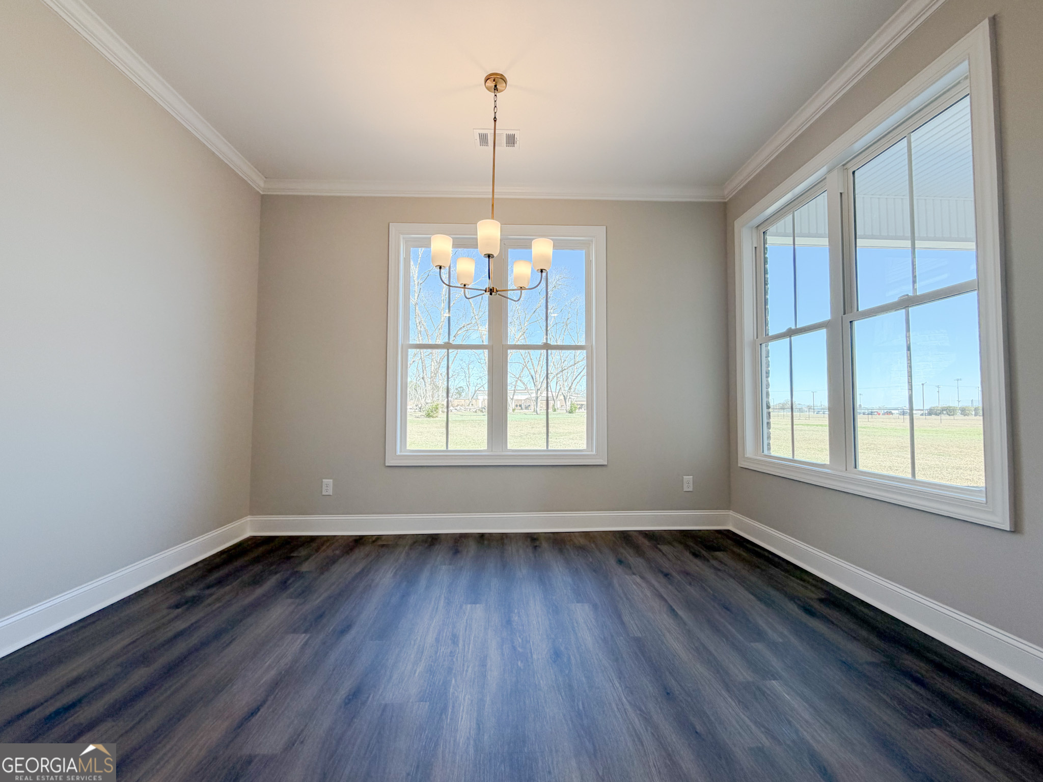 9 Honeysuckle Way Claxton, GA 30417 - Photo 43 of 84 an empty room with wooden floor and windows