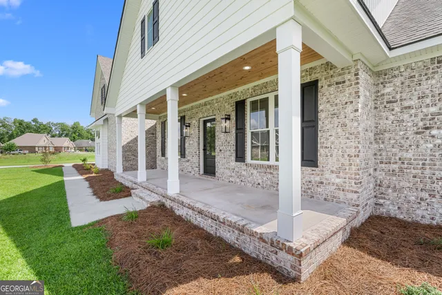 a view of a brick house with a large windows