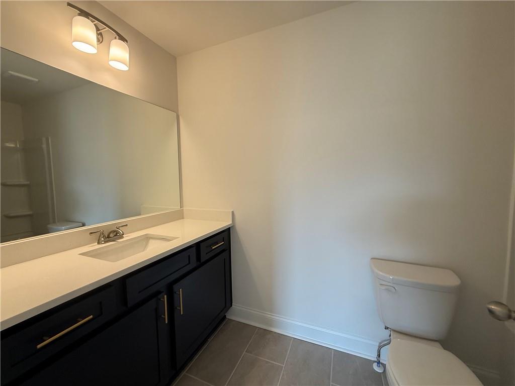 3979 Streamlet Way, Unit 153 Gainesville, GA 30506 - Photo 12 of 17 a bathroom with a sink a toilet and mirror