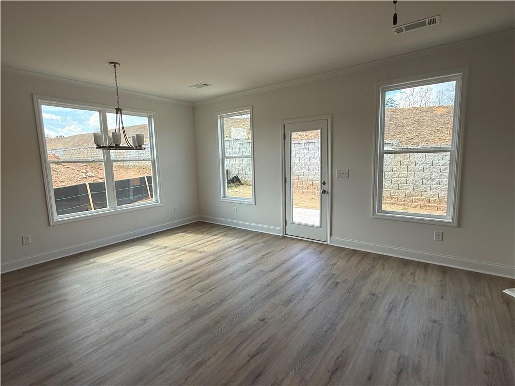 3979 Streamlet Way, Unit 153 Gainesville, GA 30506 - Photo 6 of 17 an empty room with wooden floor and windows