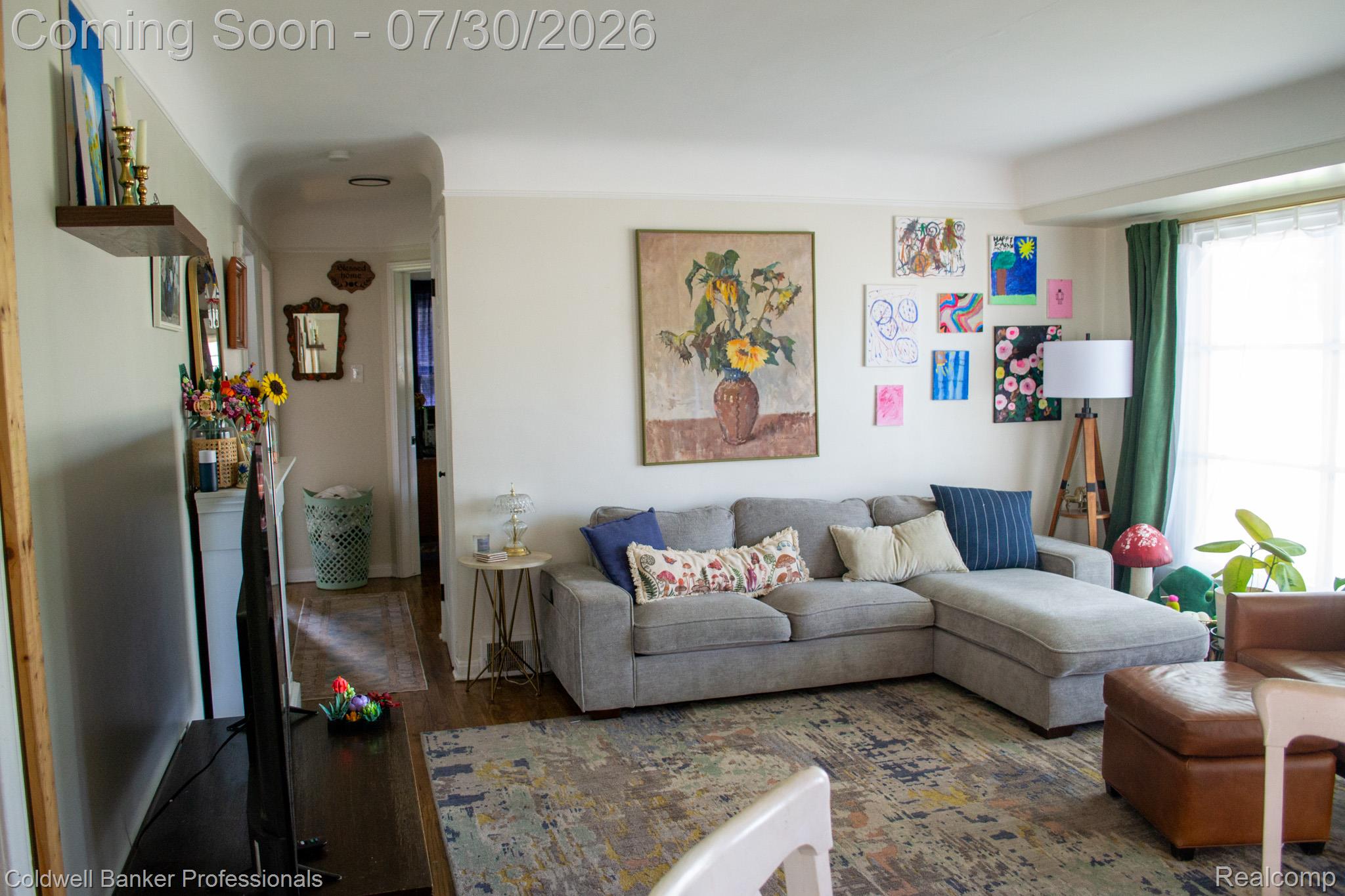 18441 Frazho Road Roseville, MI 48066 - Photo 2 of 23 Bright living room featuring wood-finish flooring and a large window with natural light