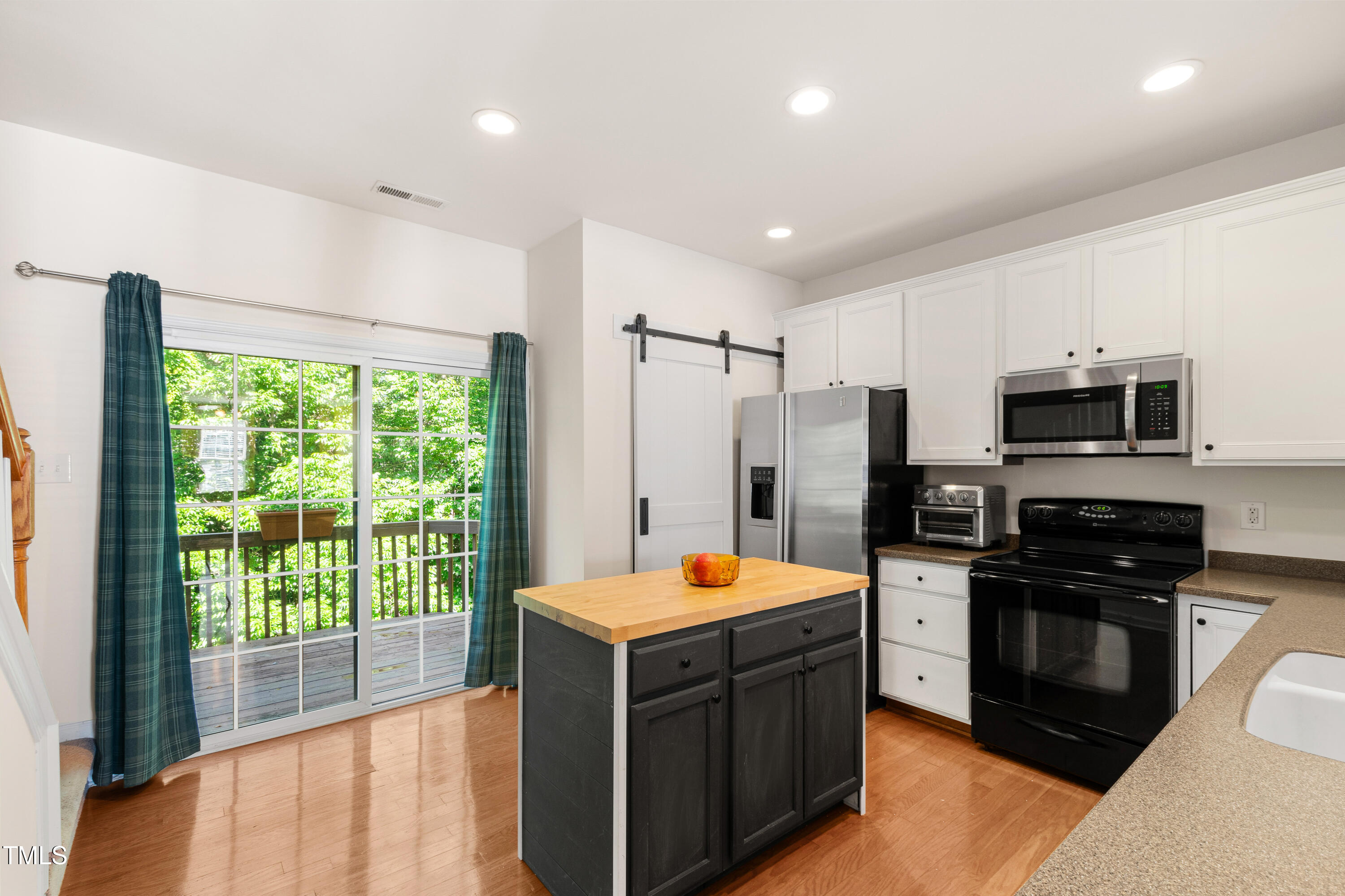 7761 Winners Edge Street Raleigh, NC 27617 - Photo 11 of 44 a large kitchen with stainless steel appliances granite countertop a refrigerator and a stove top oven