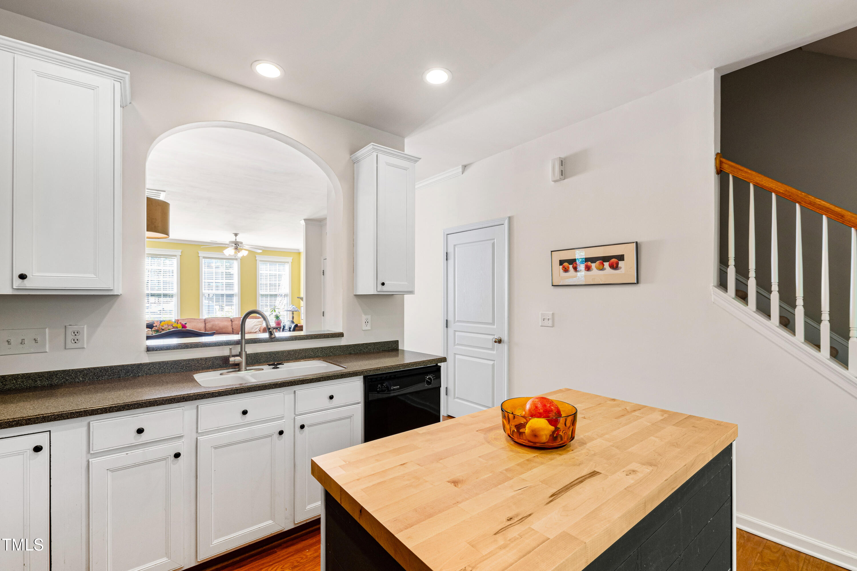 7761 Winners Edge Street Raleigh, NC 27617 - Photo 14 of 44 a kitchen with stainless steel appliances granite countertop a sink and white cabinets