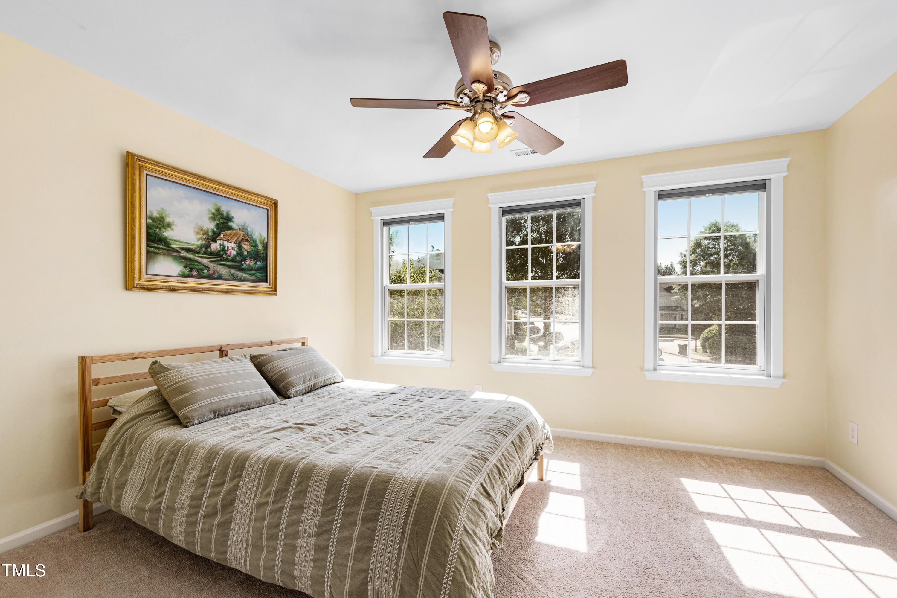7761 Winners Edge Street Raleigh, NC 27617 - Photo 19 of 44 a bedroom with a large bed and a window