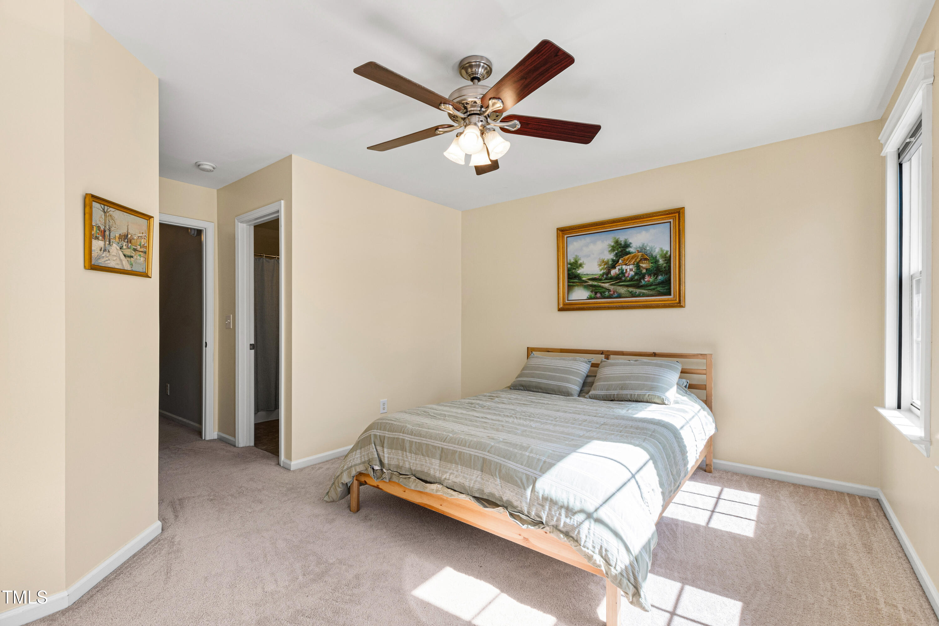 7761 Winners Edge Street Raleigh, NC 27617 - Photo 21 of 44 a bedroom with a bed and a chandelier