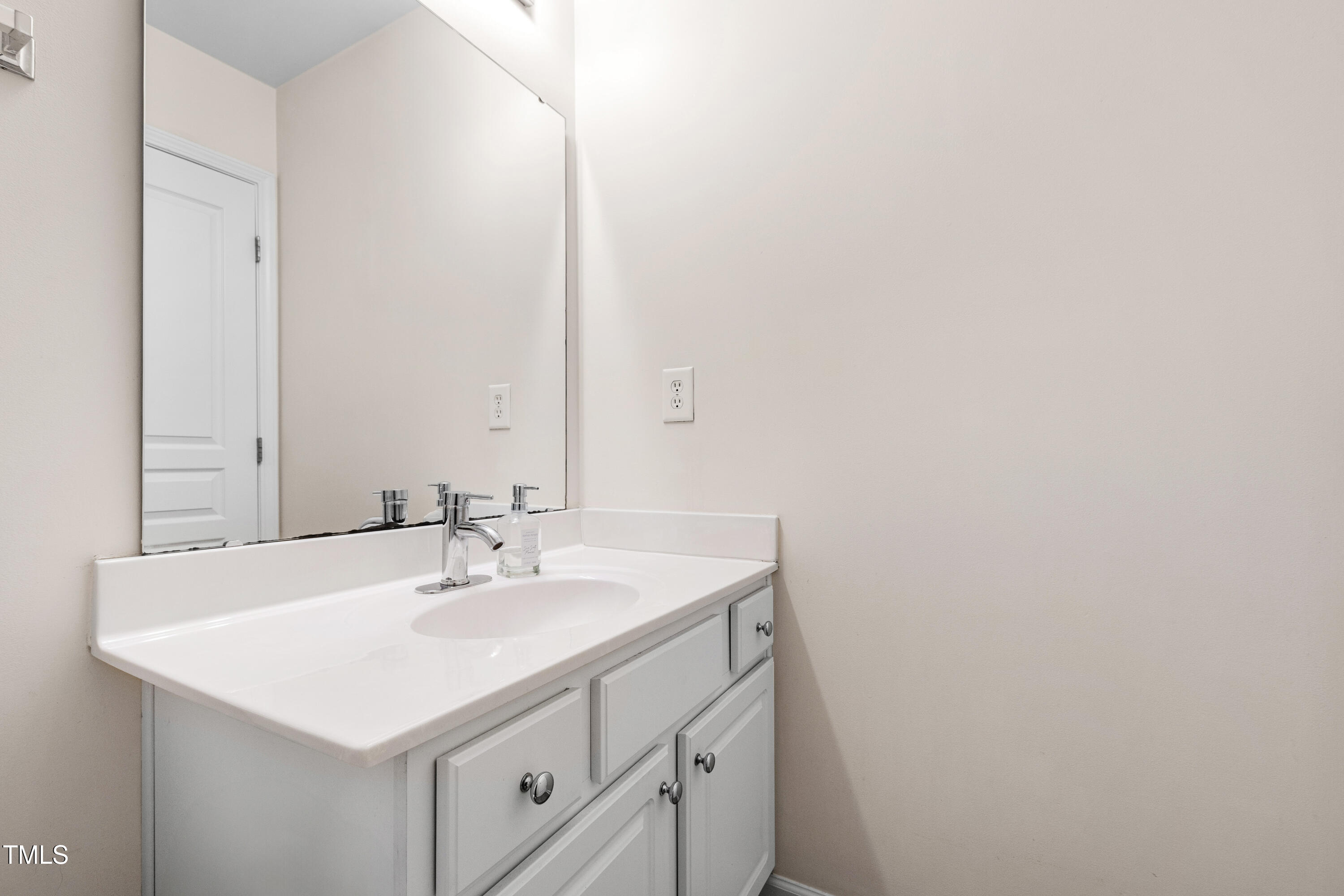 7761 Winners Edge Street Raleigh, NC 27617 - Photo 22 of 44 a bathroom with a sink and a mirror