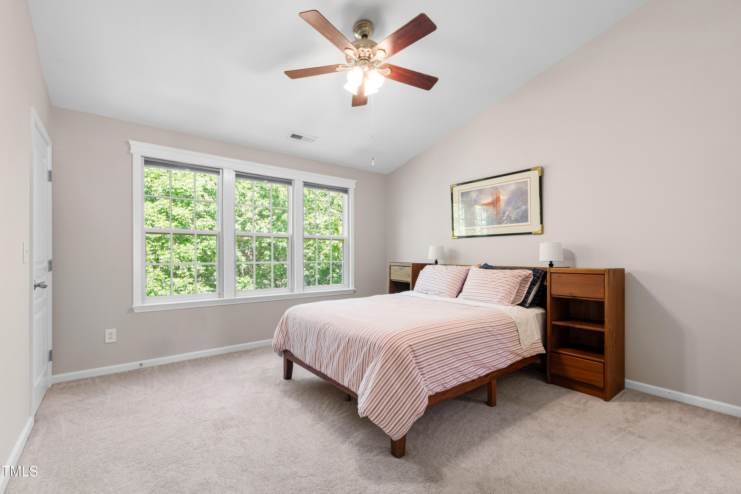 7761 Winners Edge Street Raleigh, NC 27617 - Photo 24 of 44 a bedroom with a bed and a large window