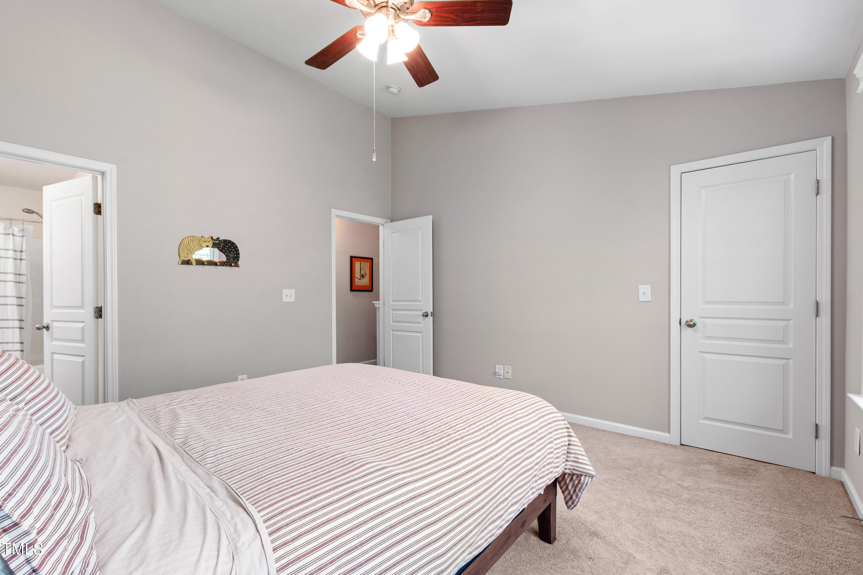 7761 Winners Edge Street Raleigh, NC 27617 - Photo 25 of 44 a bedroom with a large bed and a chandelier