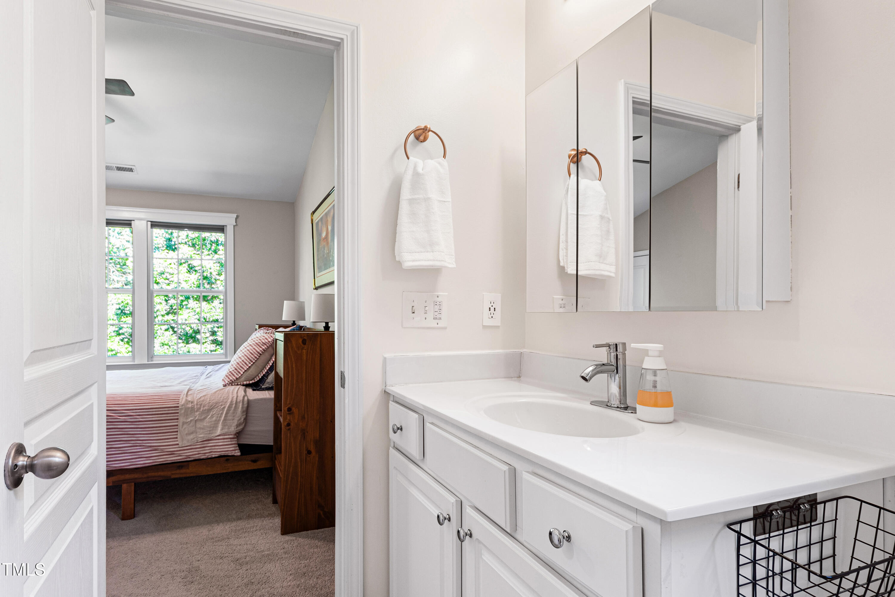 7761 Winners Edge Street Raleigh, NC 27617 - Photo 26 of 44 a en suite bathroom with a tub sink and a window