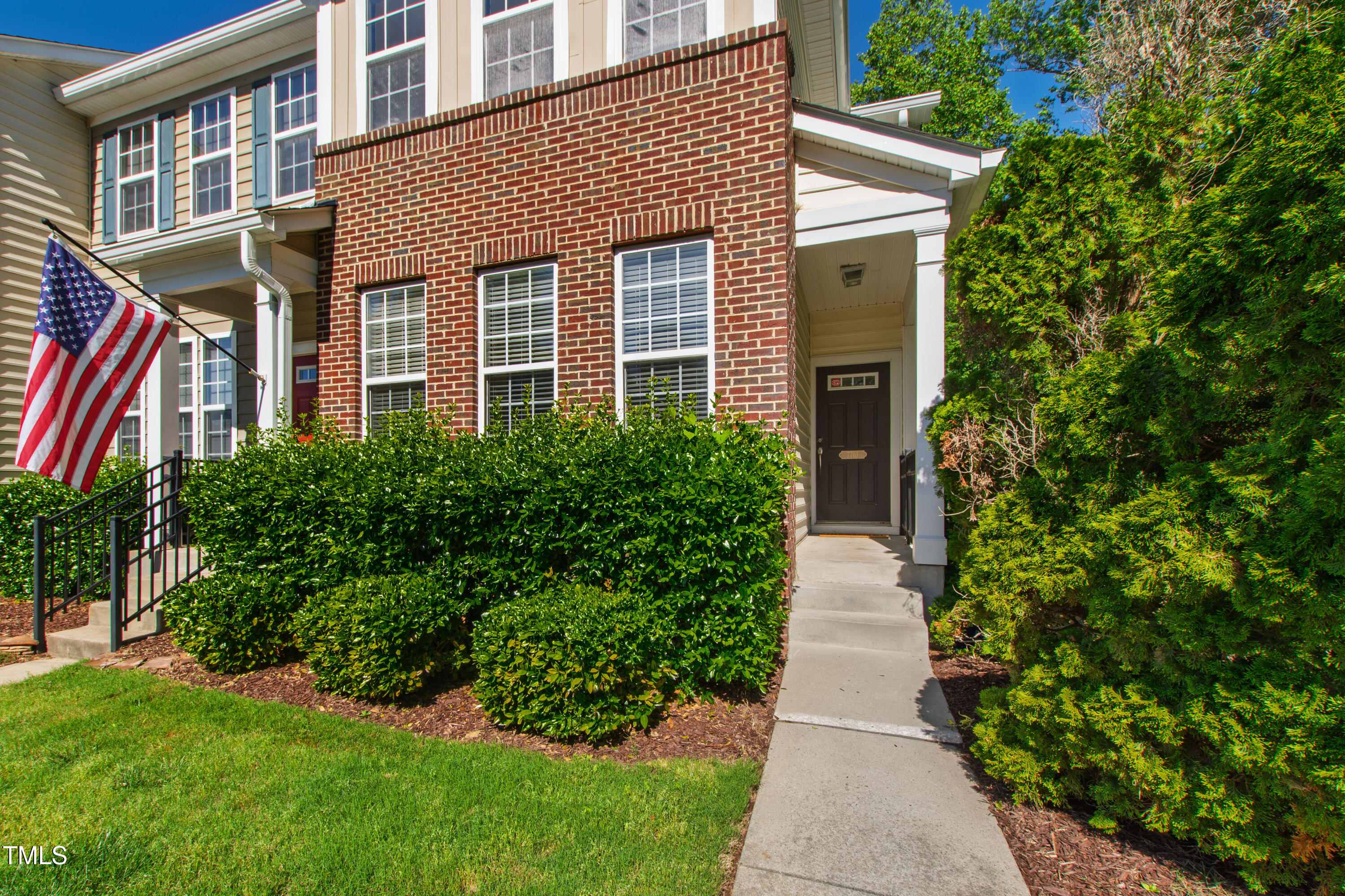 7761 Winners Edge Street Raleigh, NC 27617 - Photo 3 of 44 a front view of a house with garden and plants