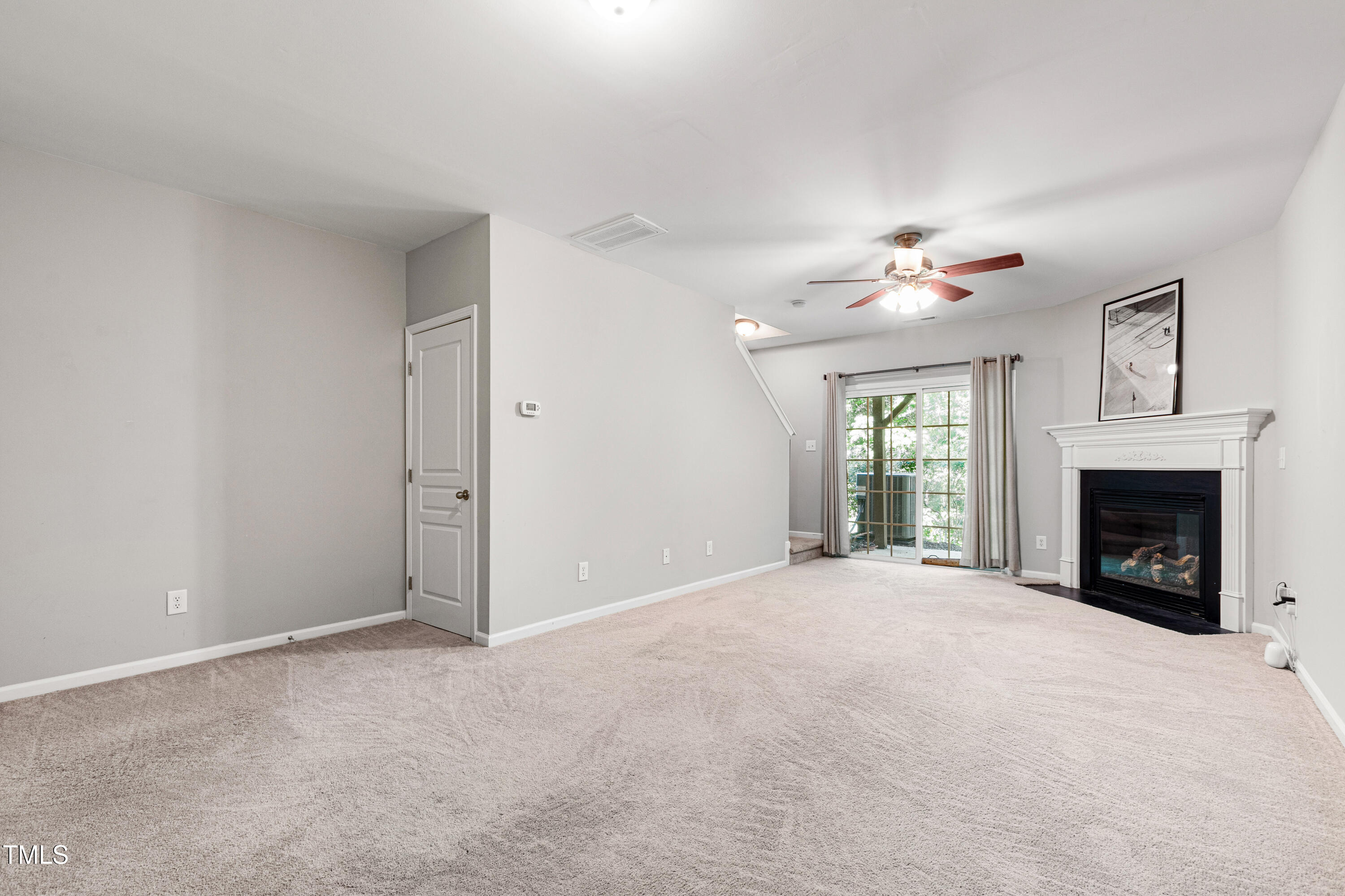 7761 Winners Edge Street Raleigh, NC 27617 - Photo 31 of 44 a view of an empty room with a fireplace