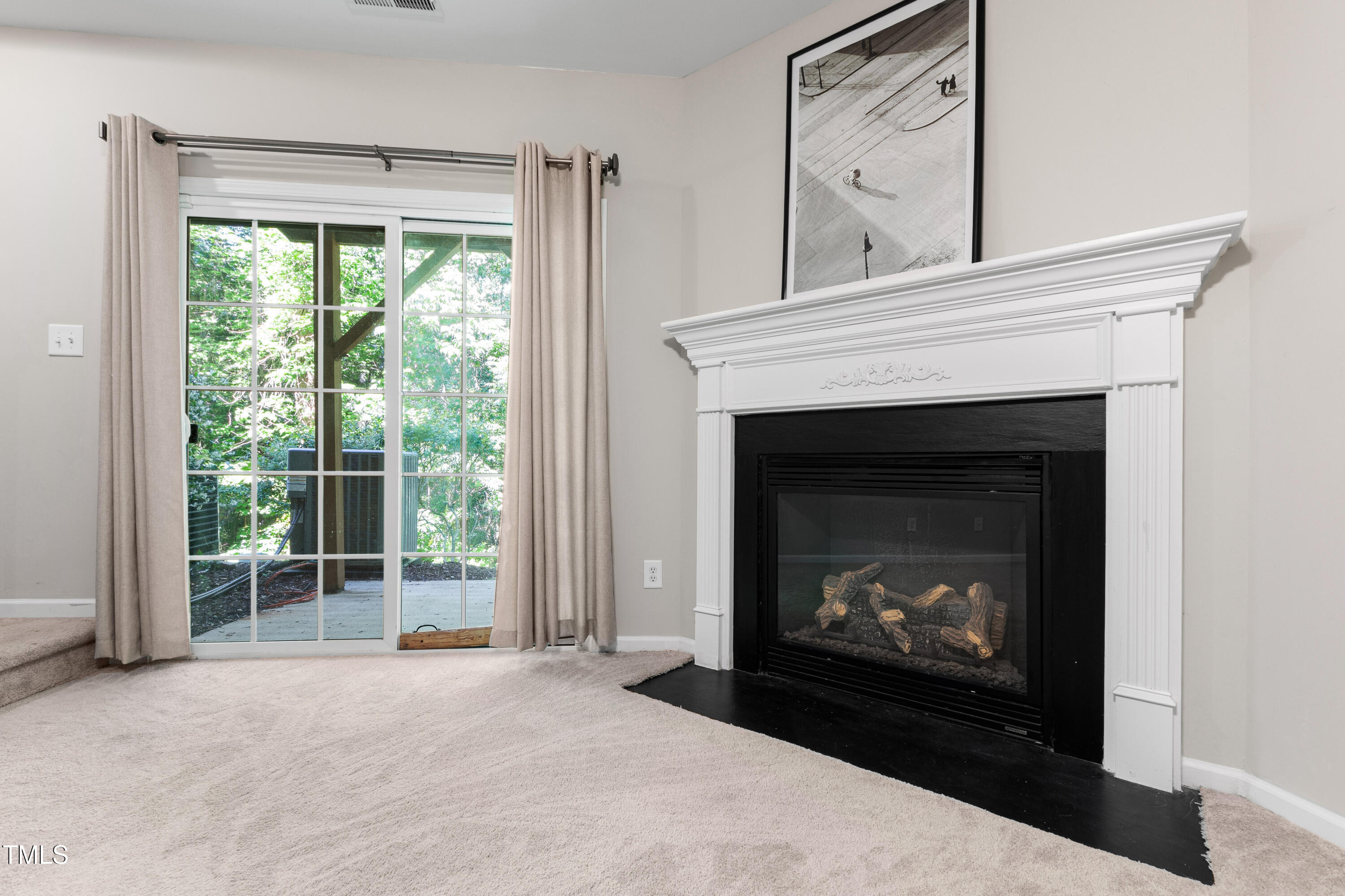 7761 Winners Edge Street Raleigh, NC 27617 - Photo 32 of 44 a living room with a fireplace with a fireplace