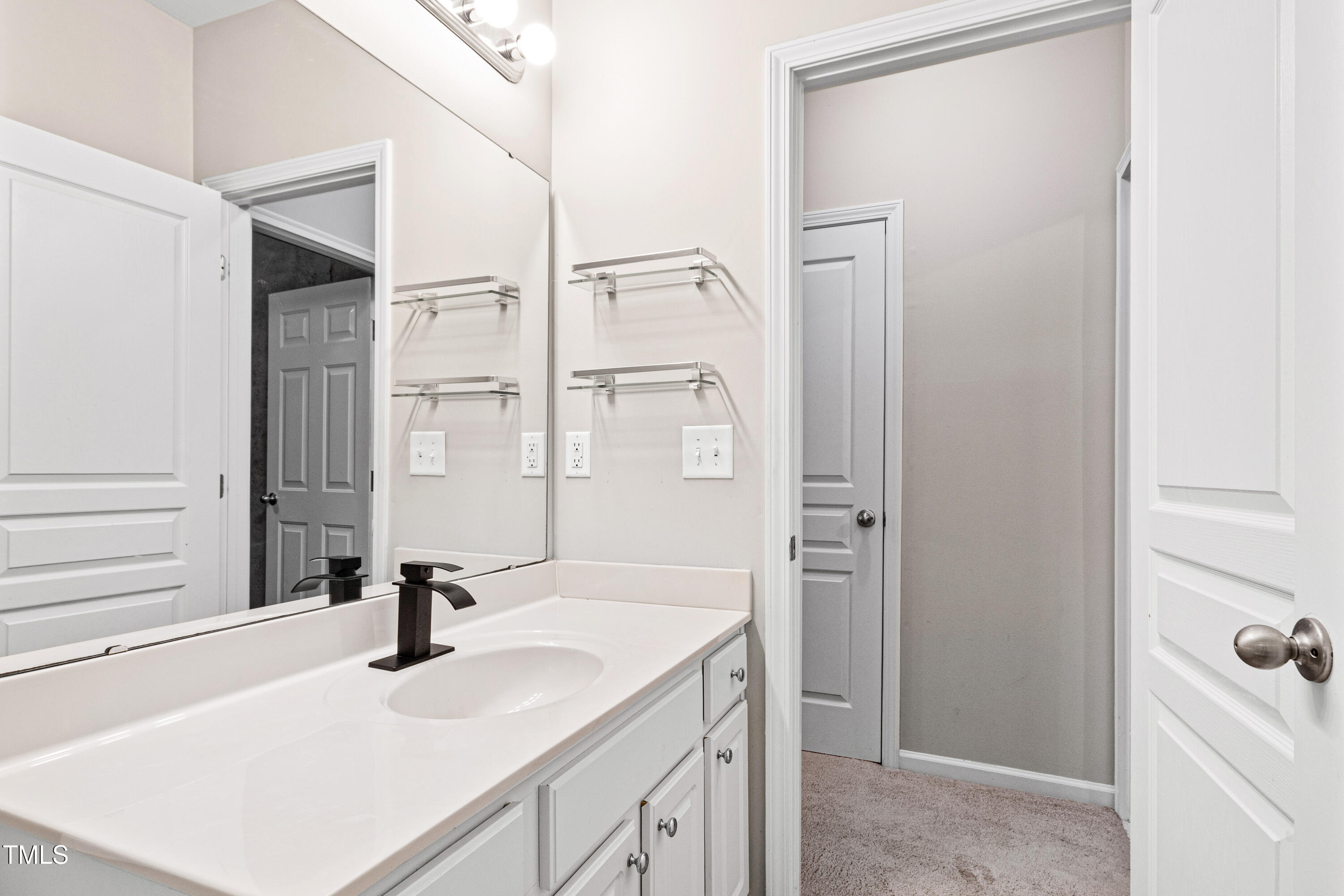 7761 Winners Edge Street Raleigh, NC 27617 - Photo 33 of 44 a bathroom with a sink and a mirror