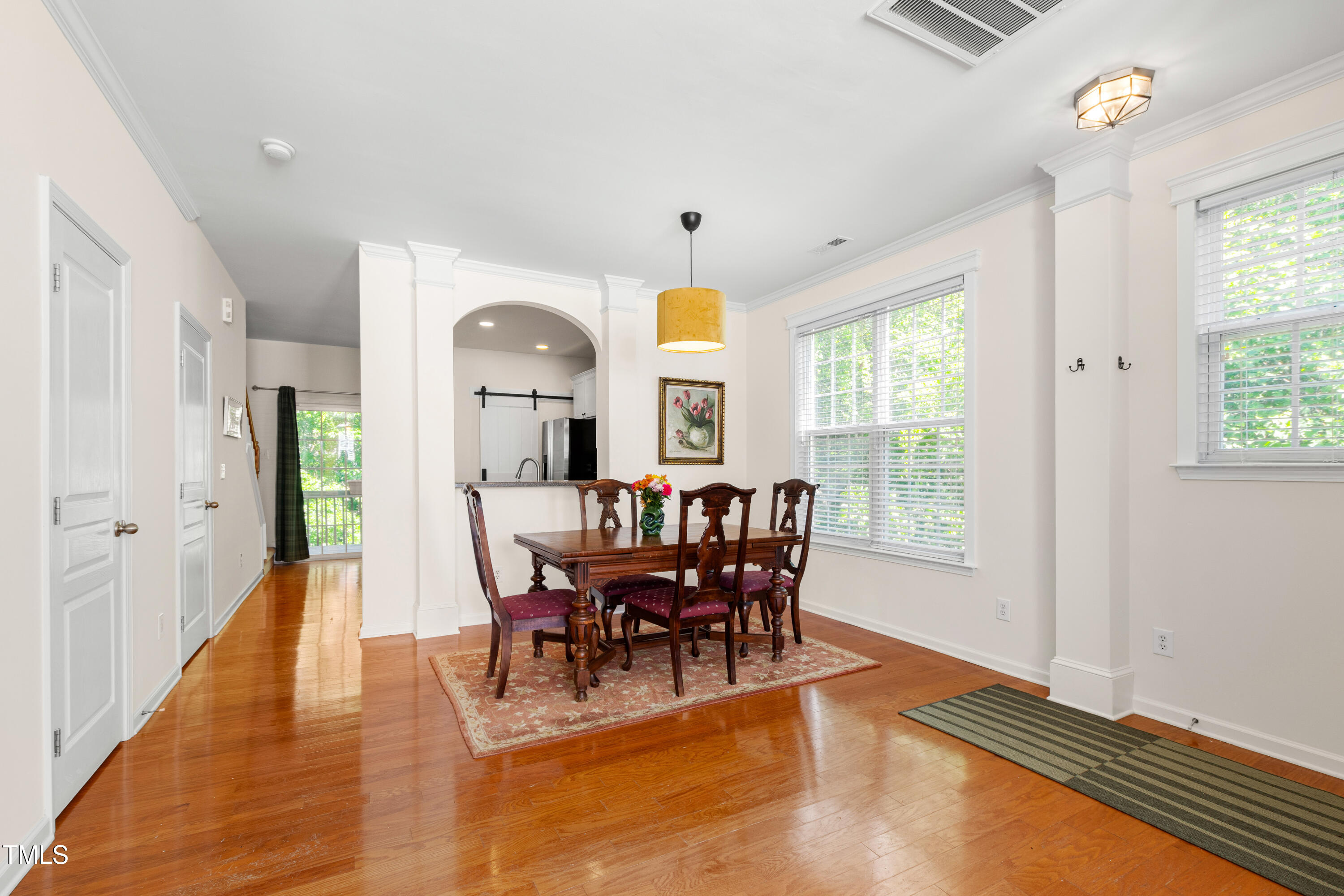 7761 Winners Edge Street Raleigh, NC 27617 - Photo 5 of 44 a view of a dining room with furniture window and wooden floor