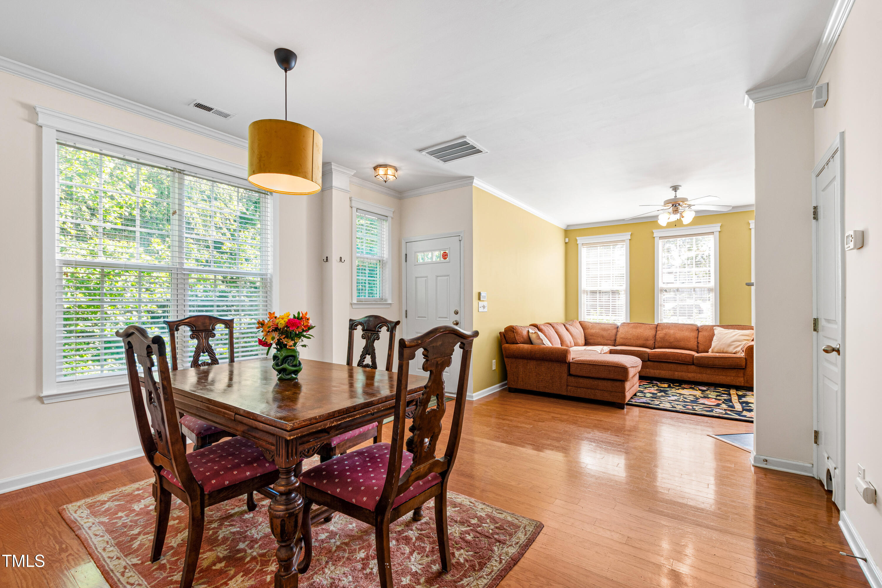 7761 Winners Edge Street Raleigh, NC 27617 - Photo 9 of 44 a dining room with furniture and wooden floor