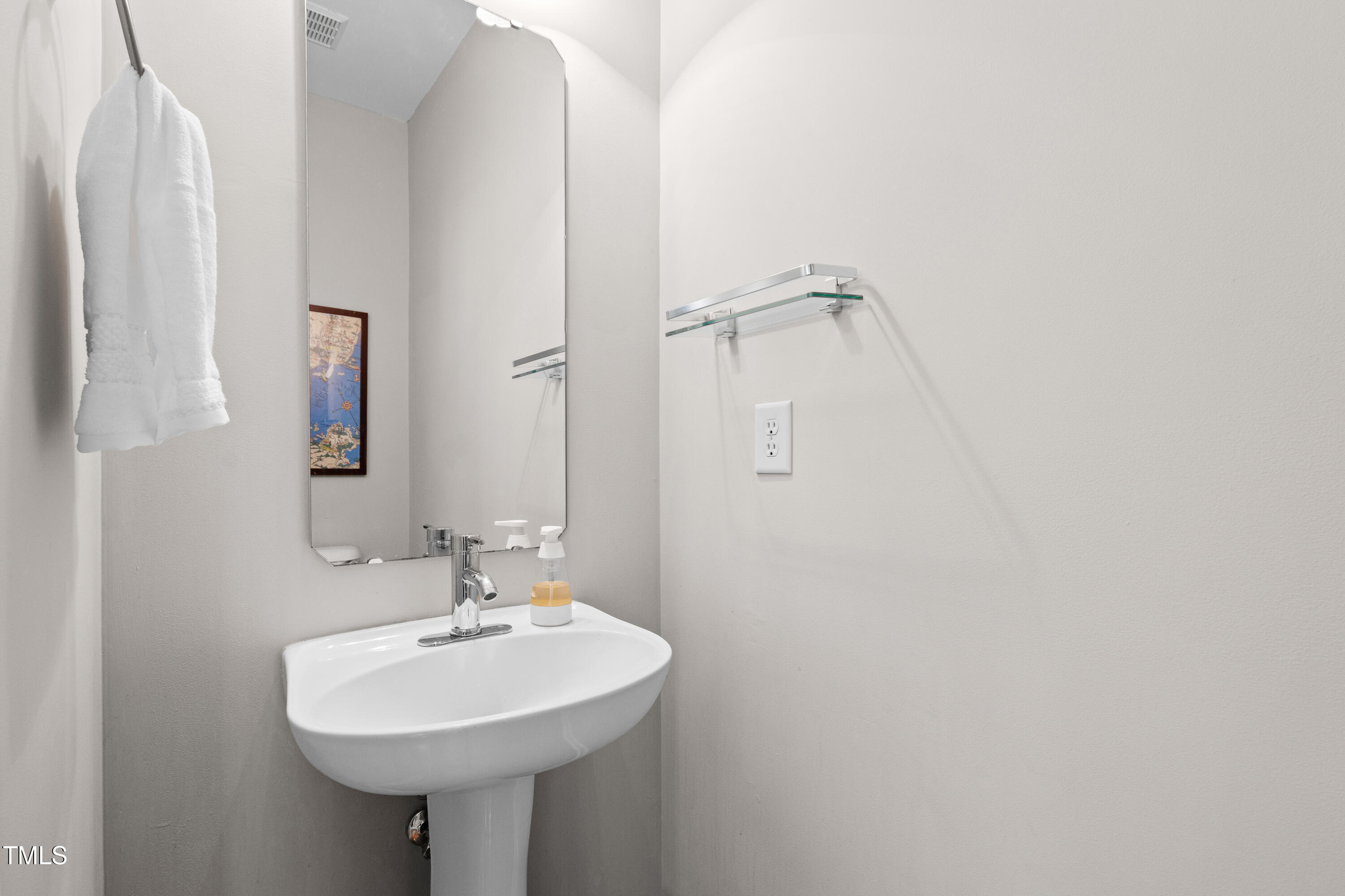 7761 Winners Edge Street Raleigh, NC 27617 - Photo 10 of 44 a bathroom with a sink a mirror and a shower