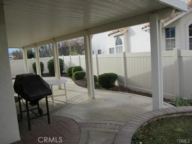 a building outdoor space with patio furniture and potted plants