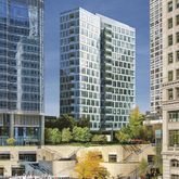 a front view of a building with swimming pool and outdoor seating