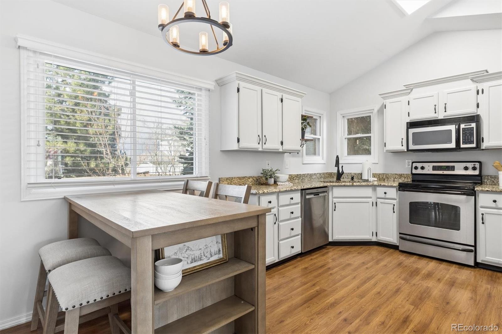 7191 Palisade Drive Highlands Ranch, CO 80130 - Photo 11 of 39 a kitchen with a stove a sink and a microwave