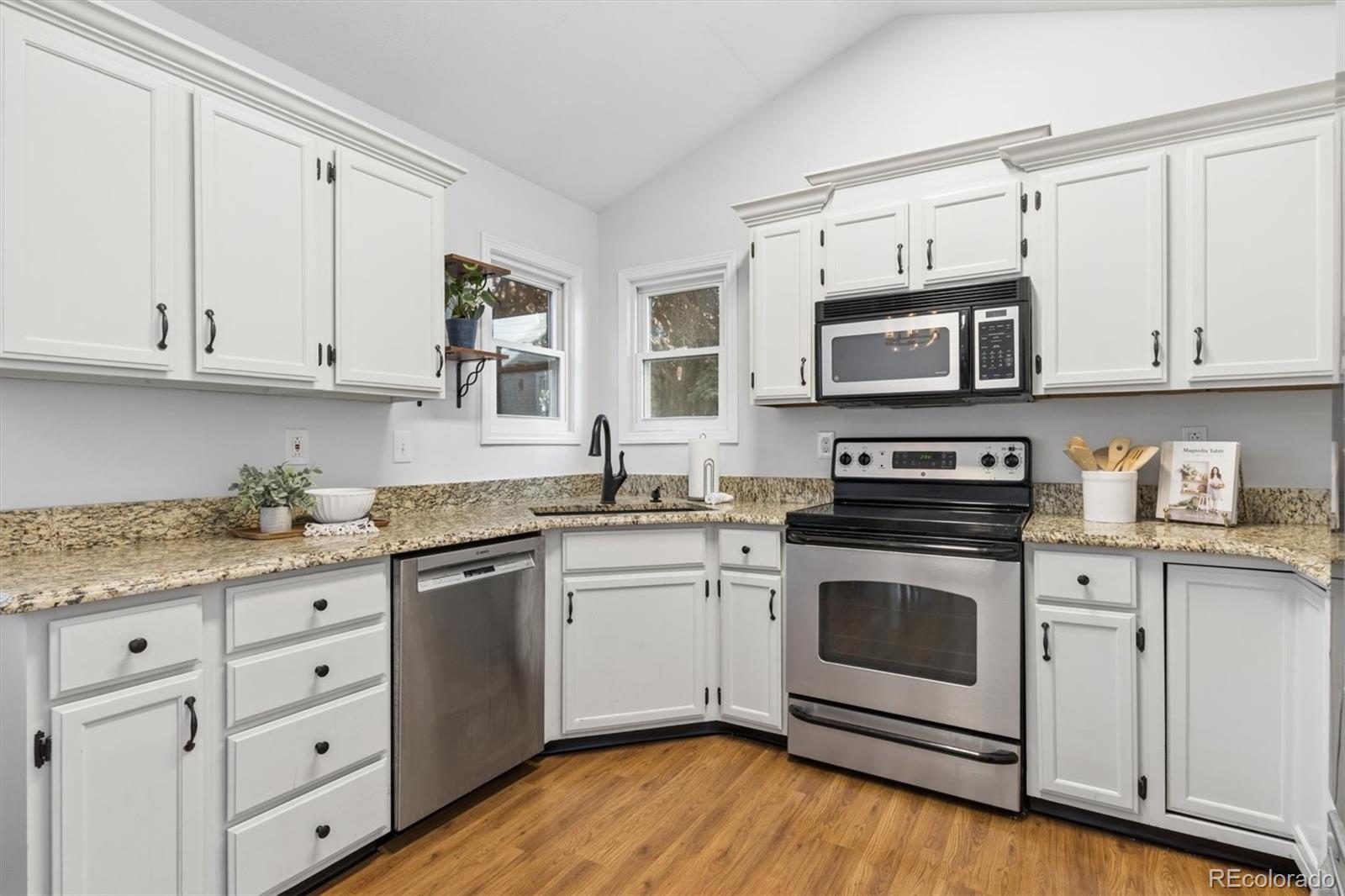 7191 Palisade Drive Highlands Ranch, CO 80130 - Photo 13 of 39 a kitchen with granite countertop cabinets stainless steel appliances and a sink