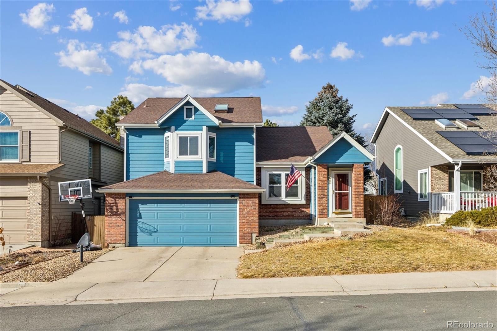 7191 Palisade Drive Highlands Ranch, CO 80130 - Photo 2 of 39 a front view of a house with a yard