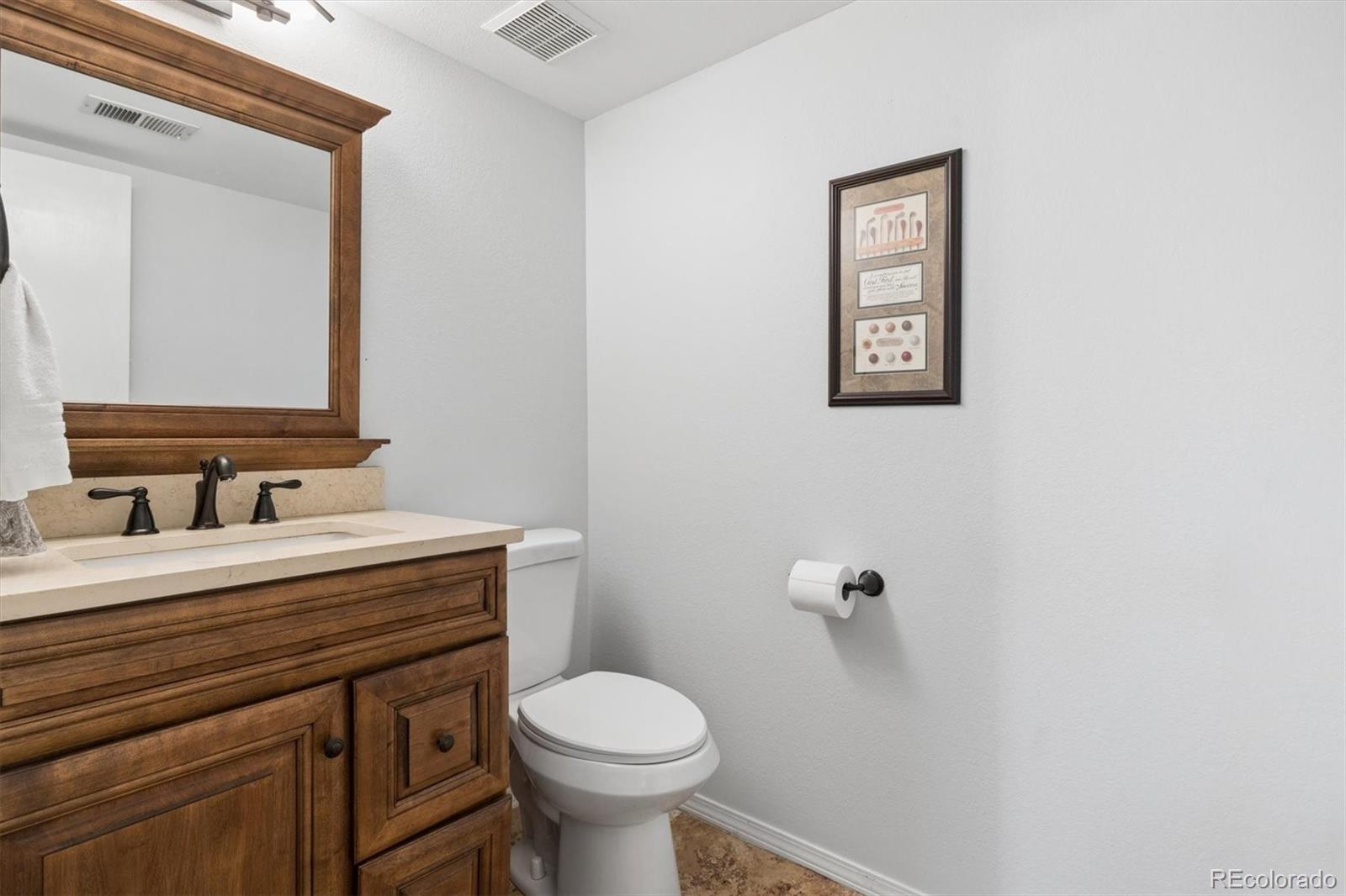 7191 Palisade Drive Highlands Ranch, CO 80130 - Photo 21 of 39 a bathroom with a sink a toilet and mirror