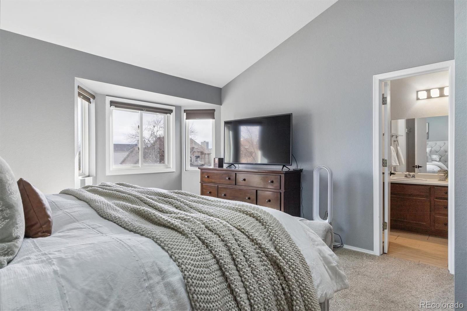 7191 Palisade Drive Highlands Ranch, CO 80130 - Photo 24 of 39 a bedroom with a bed and a flat screen tv